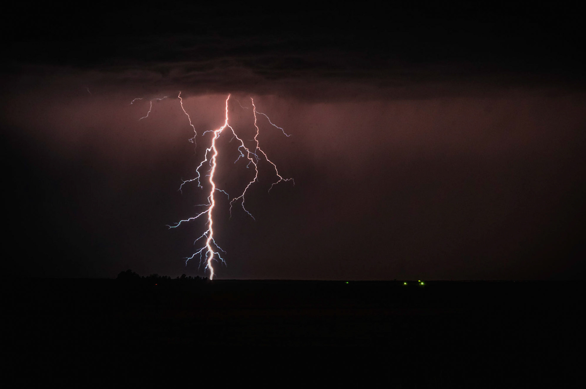 A strong lightning bolts strikes the earth near Burlington, Colorado