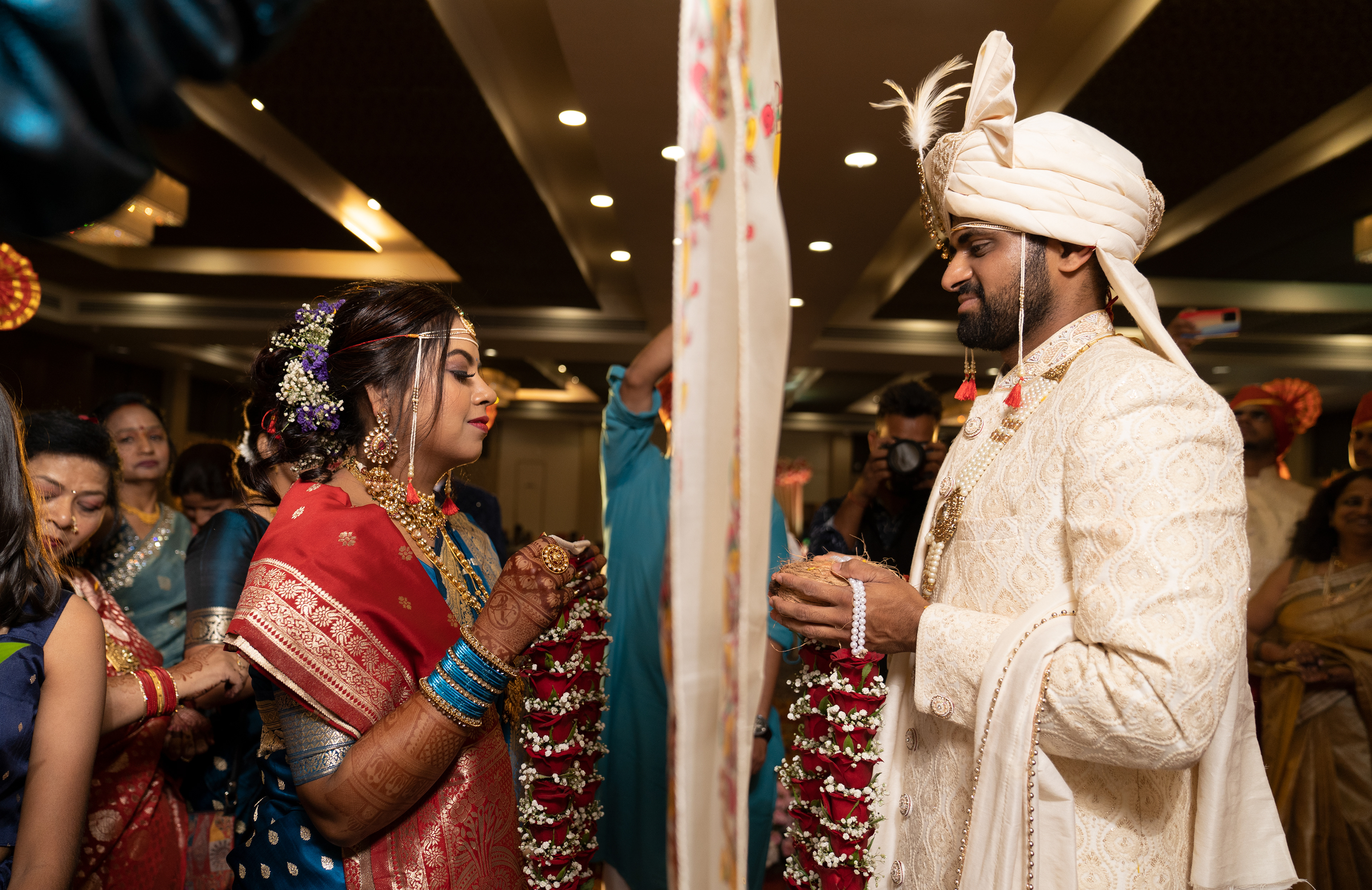 A heartwarming moment between the bride and groom, as they exchange vows, promising to cherish each other forever| Image captured by best wedding photographer in Pune