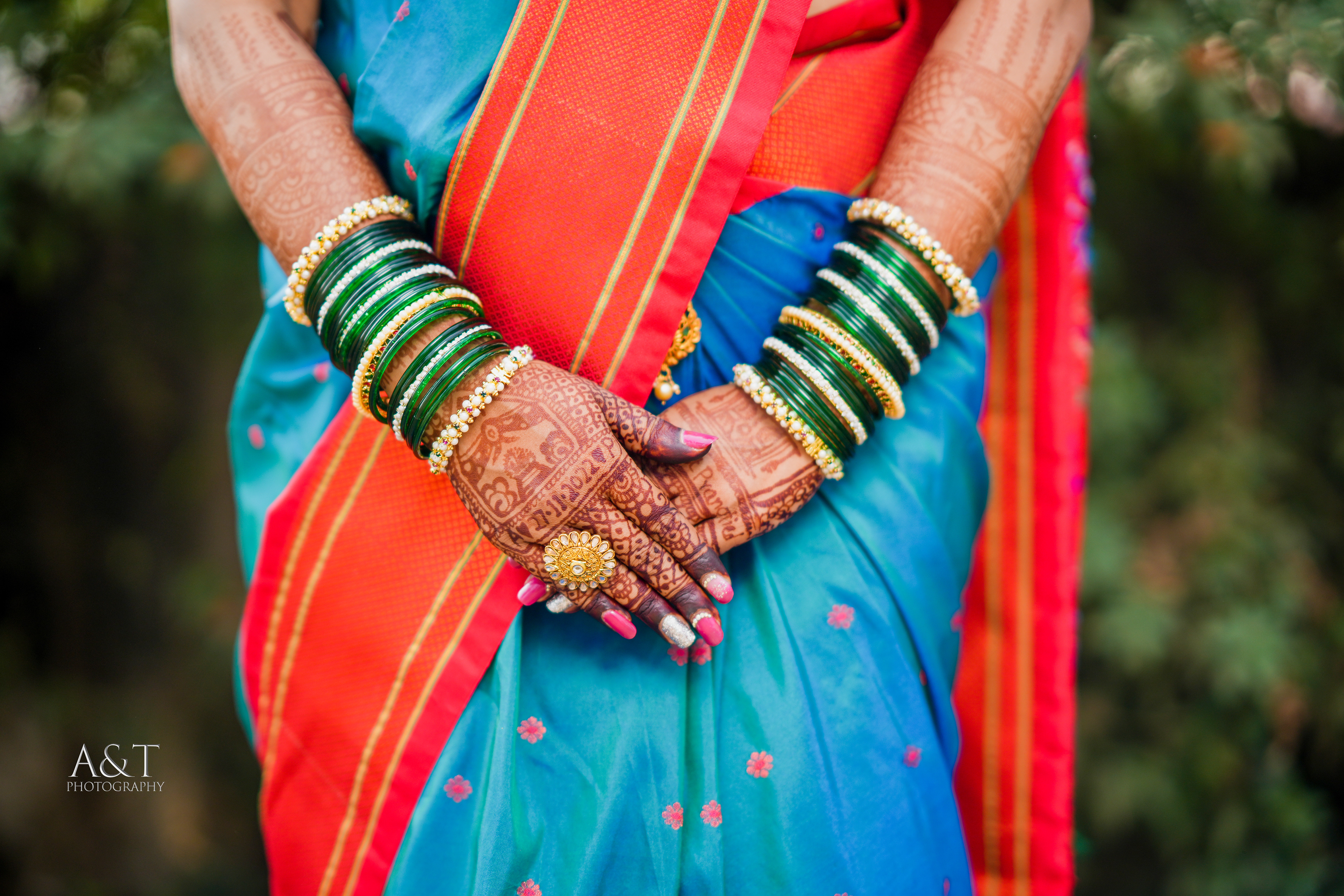 Close-up of a bride's hands, beautifully decorated with henna designs| This image is beautifully captured by Best Wedding Photographer in Pune- A&T Photography