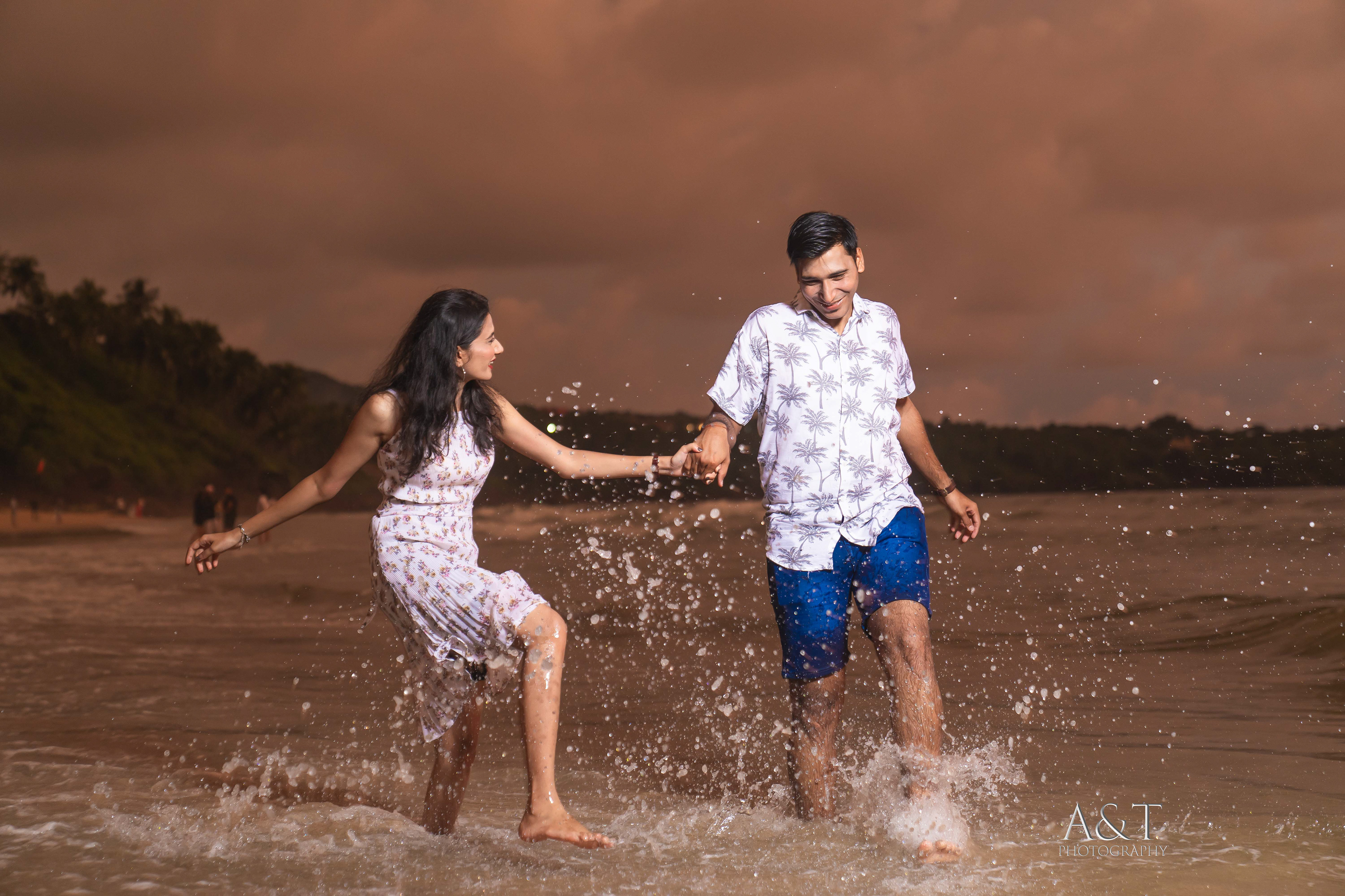 Splashing water on each other creates a wonderful memory together. Amazing pre-wedding moment captured by A&T Photography