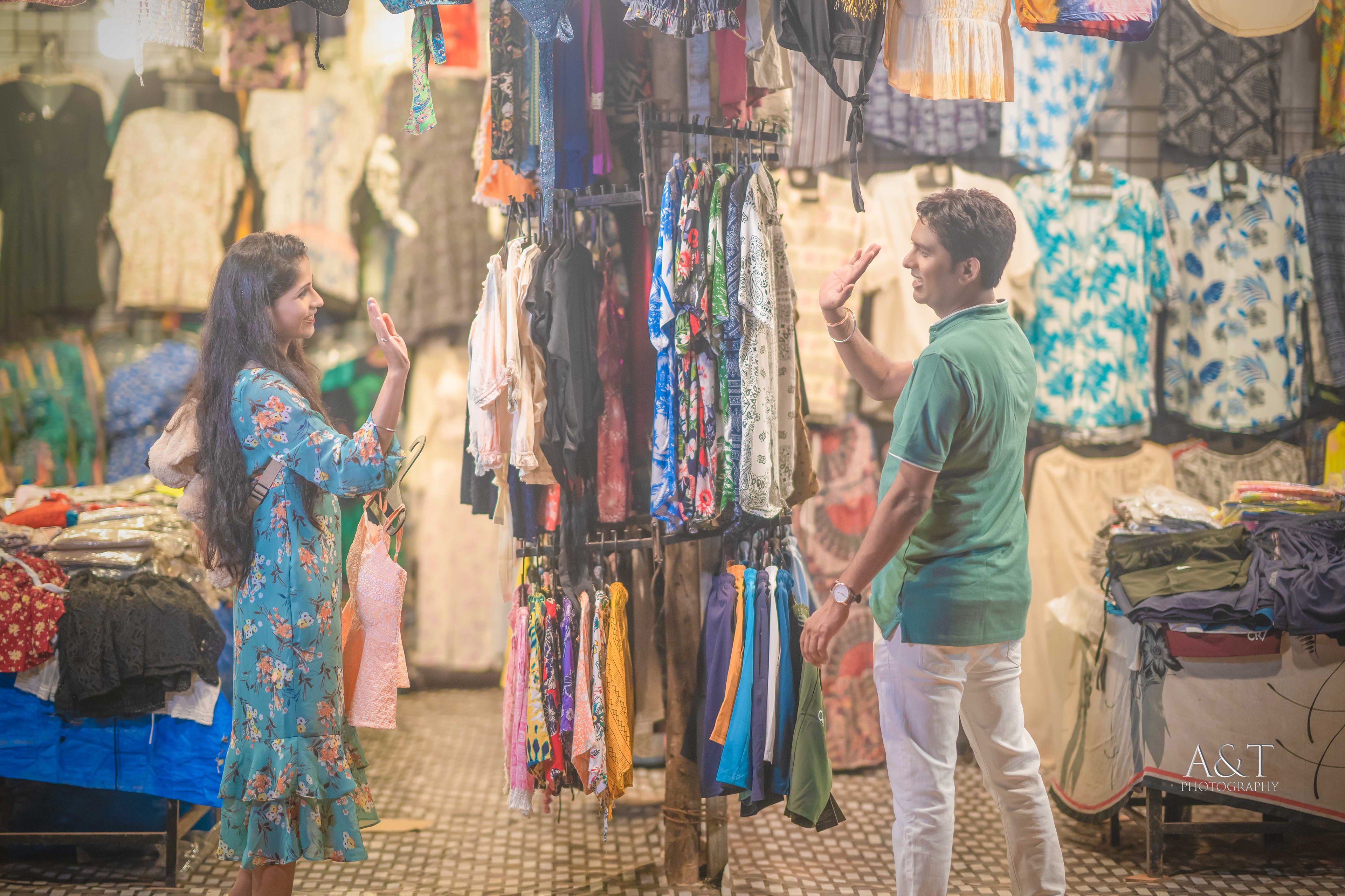 Playful pre-wedding moment - Sanket and Komal enjoy shopping on Goa's lively streets| Captured by Best Wedding Photographer in Goa