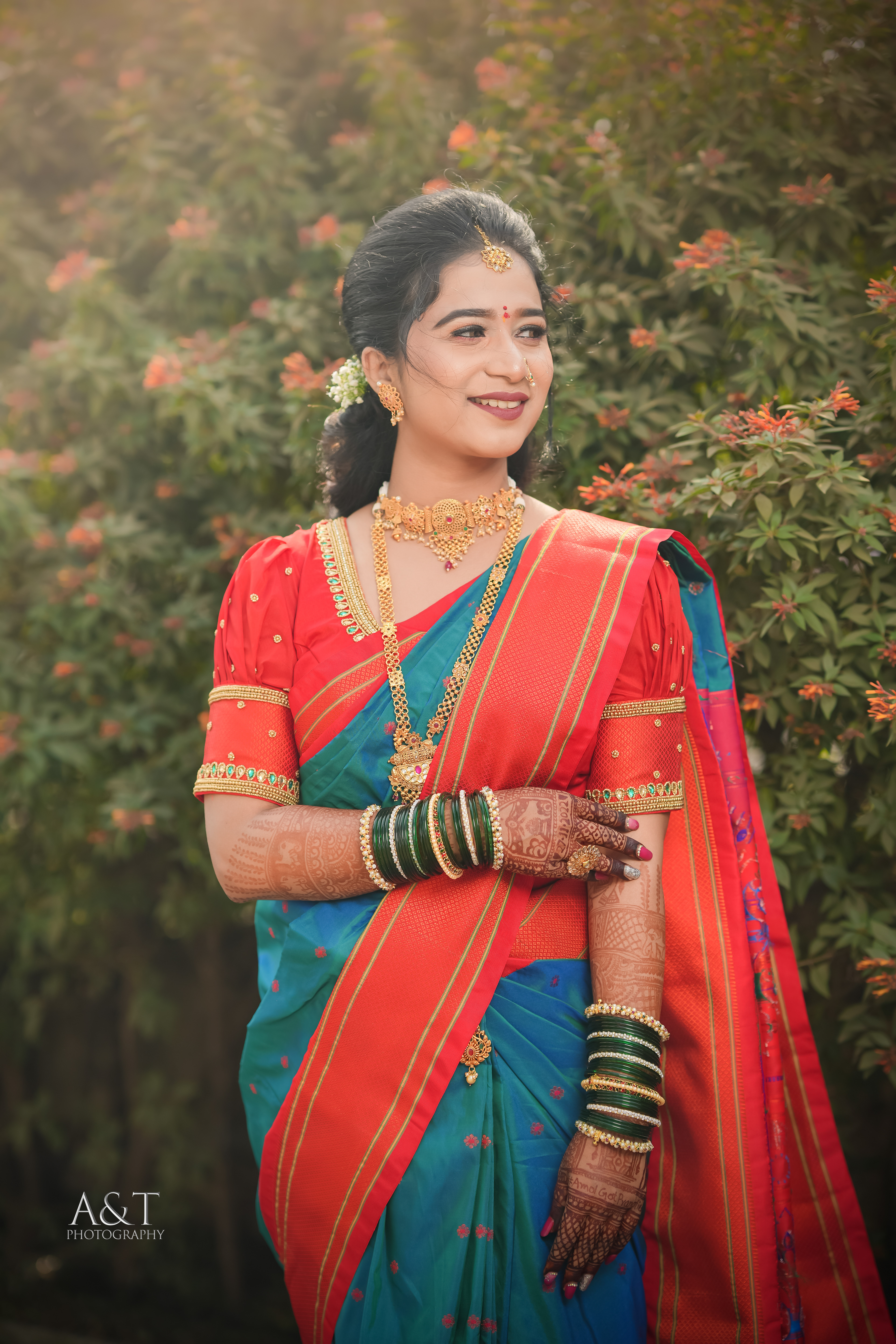 Stunning Maharashtrian bride in a resplendent blue Paithani silk saree, in a stunning photograph by A&T Photography