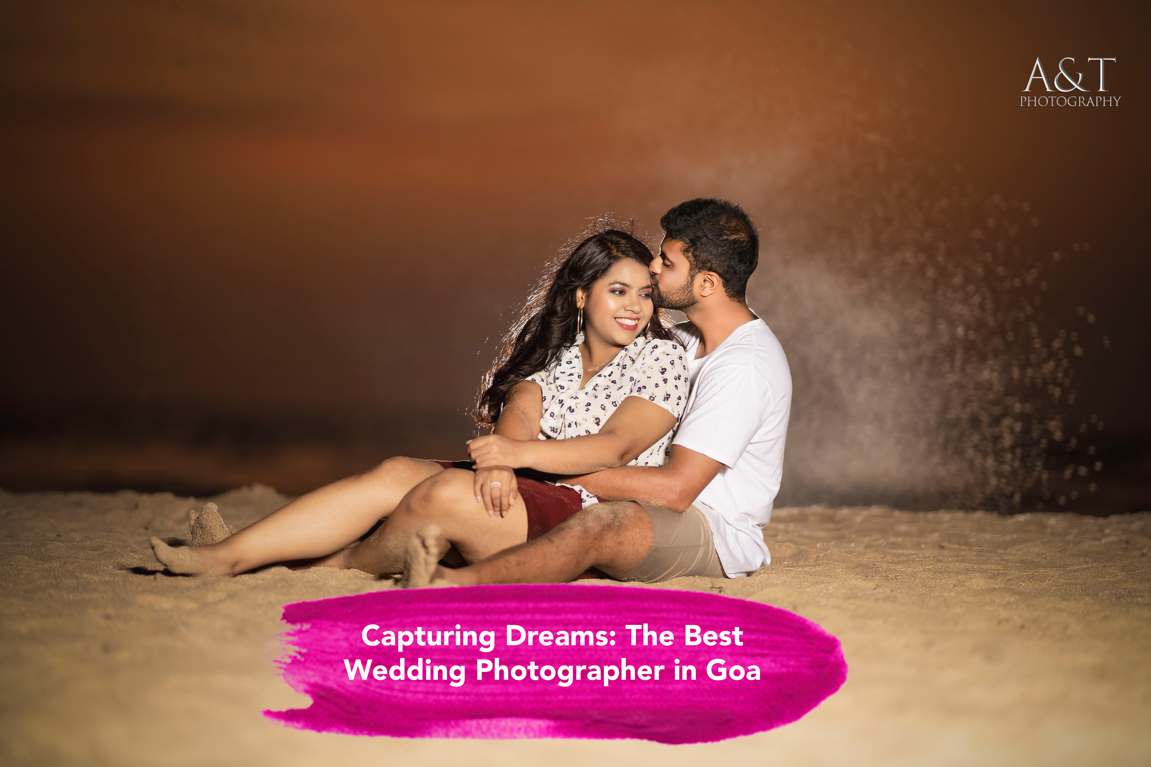 Smiling couple embracing on a sandy beach during their pre-wedding shoot in Goa captured by A&T Photography