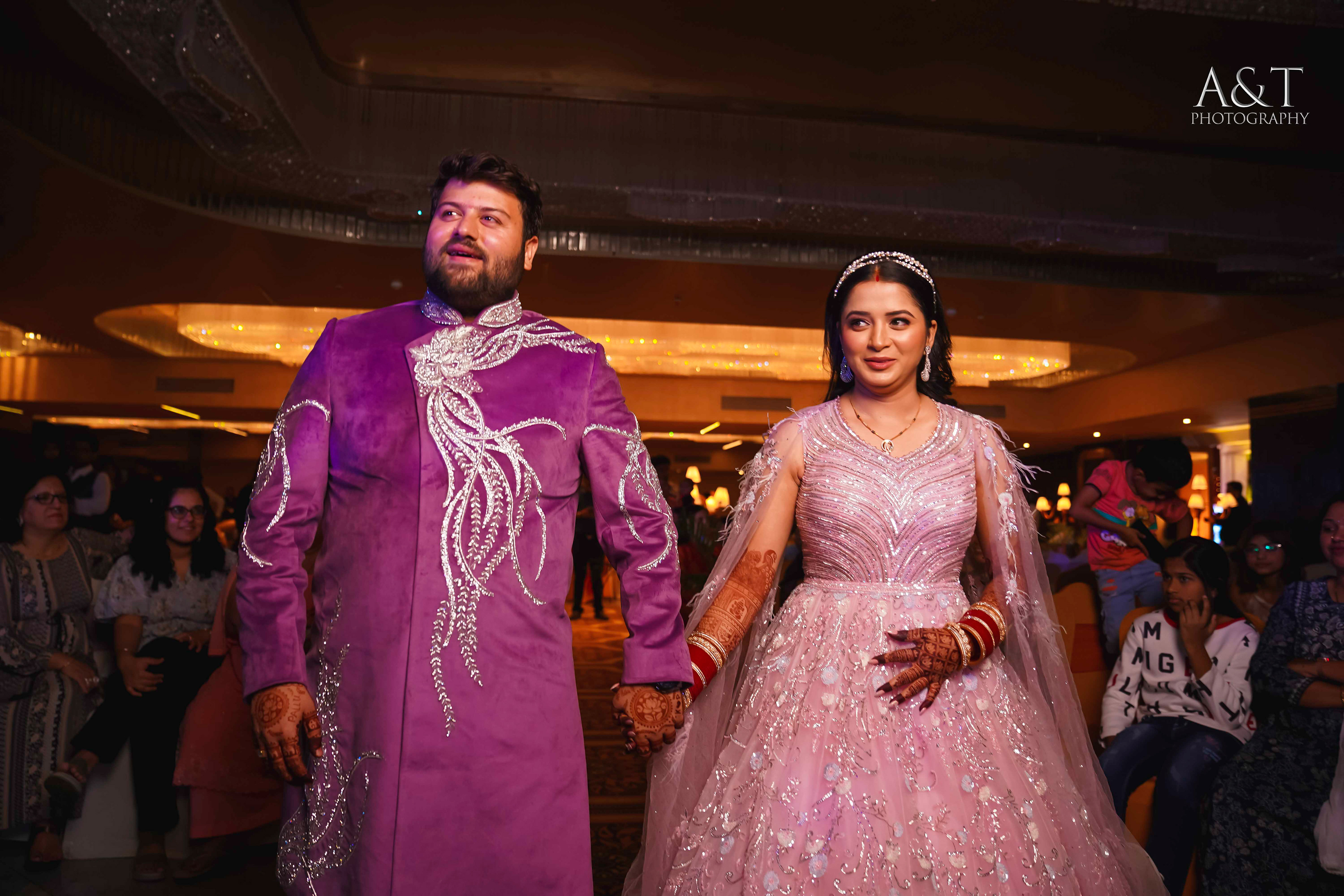Bride and groom walking down the aisle, hand in hand, surrounded by loved ones