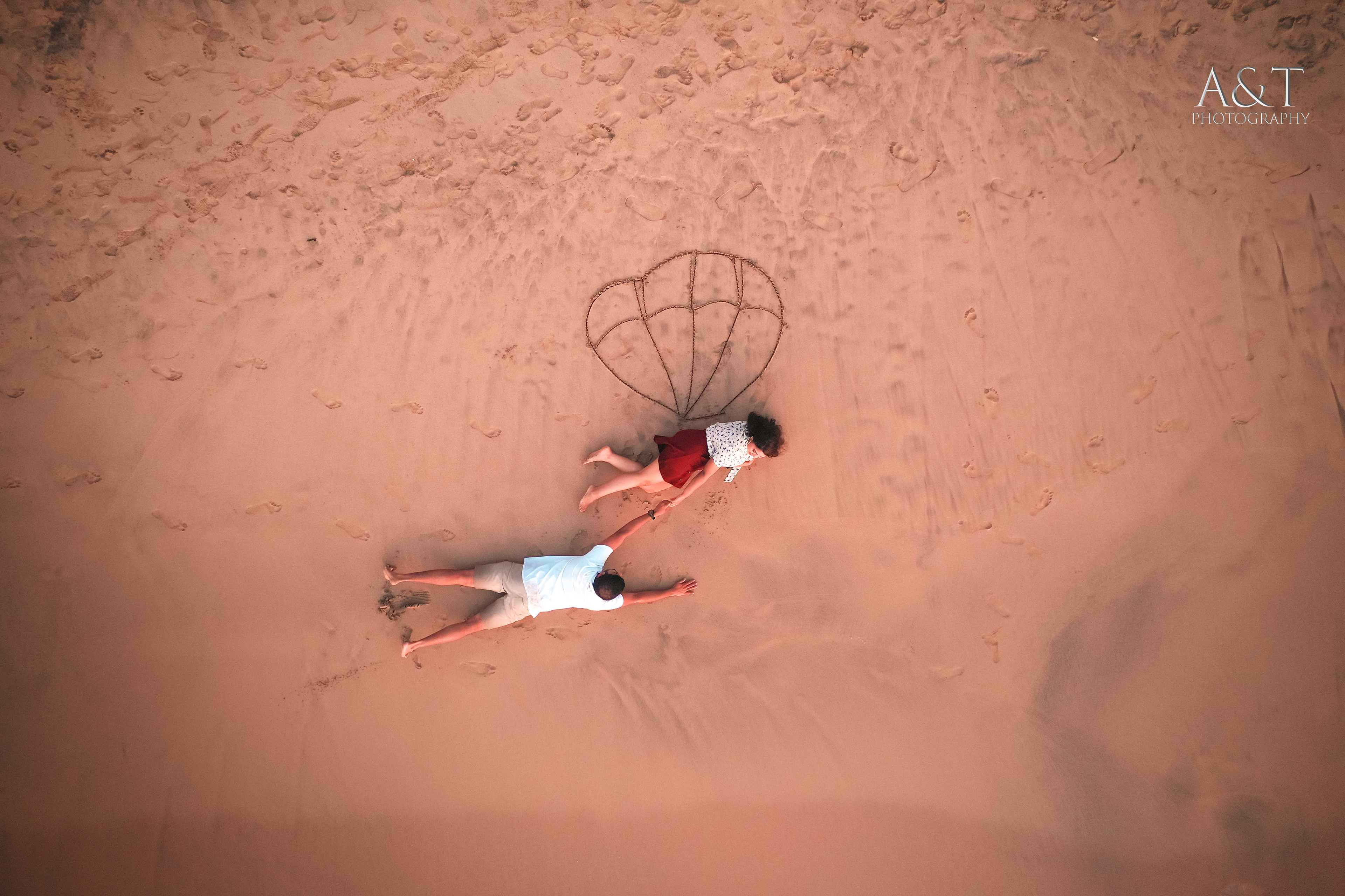 Joyful couple sharing a laughter-filled moment in the scenic beauty of Goa captured by Drone| Aerial Prewedding Shoot in Goa
