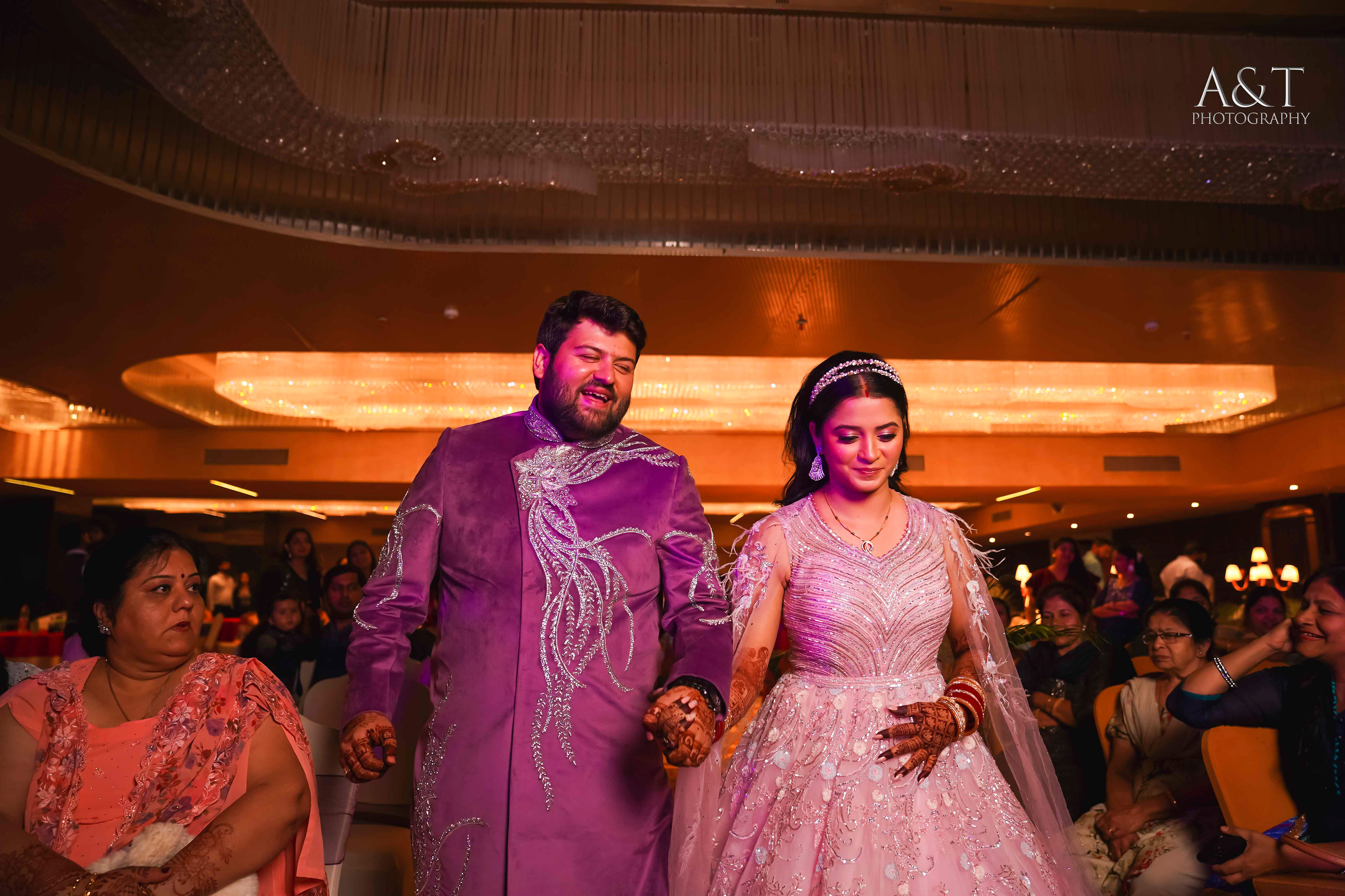 Bride and groom walking down the aisle, hand in hand, surrounded by loved ones at their destination wedding in Mahabaleshwar