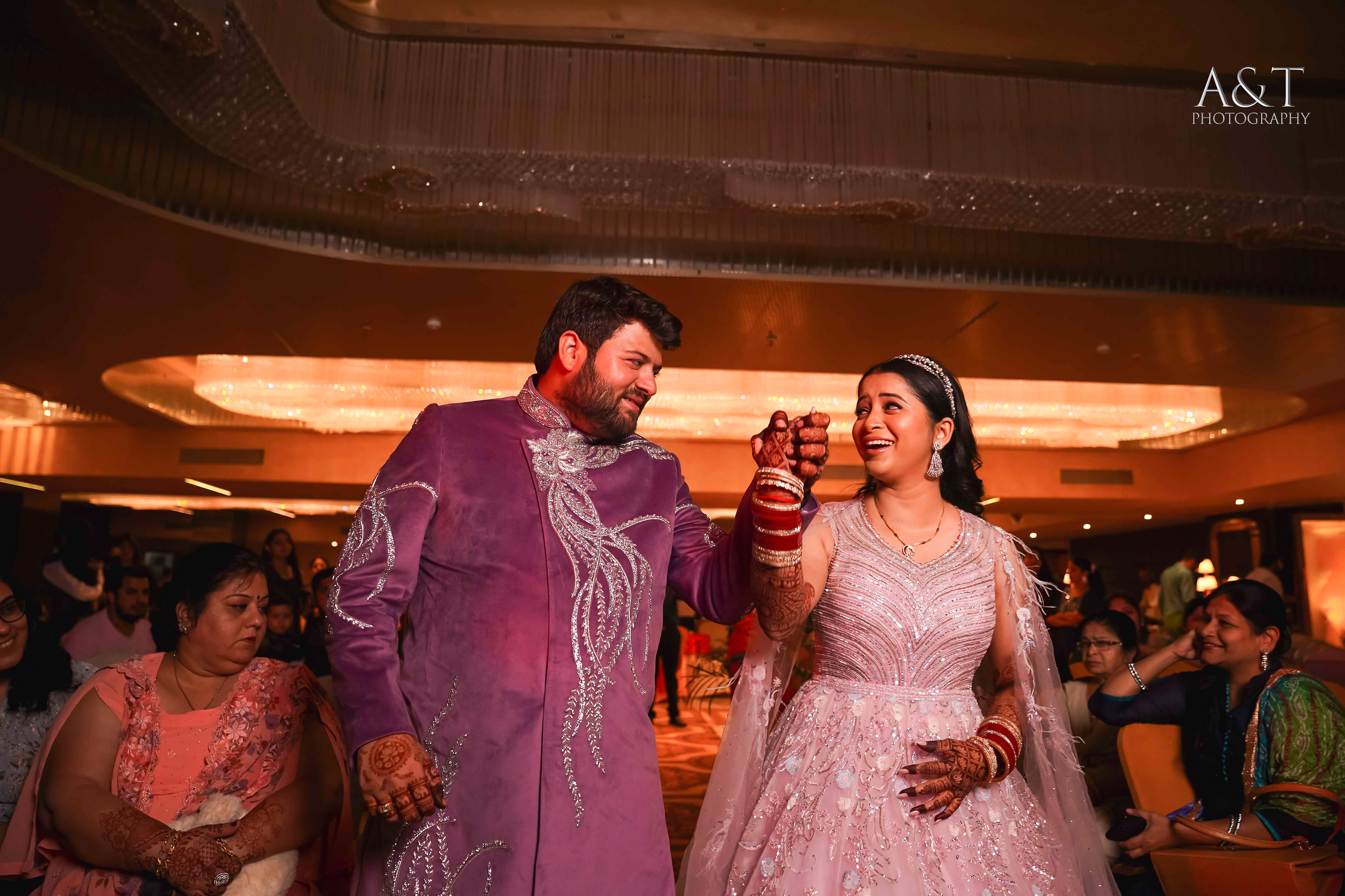 Bride and groom walking down the aisle, hand in hand, surrounded by loved ones captured by best wedding photographers in Pune