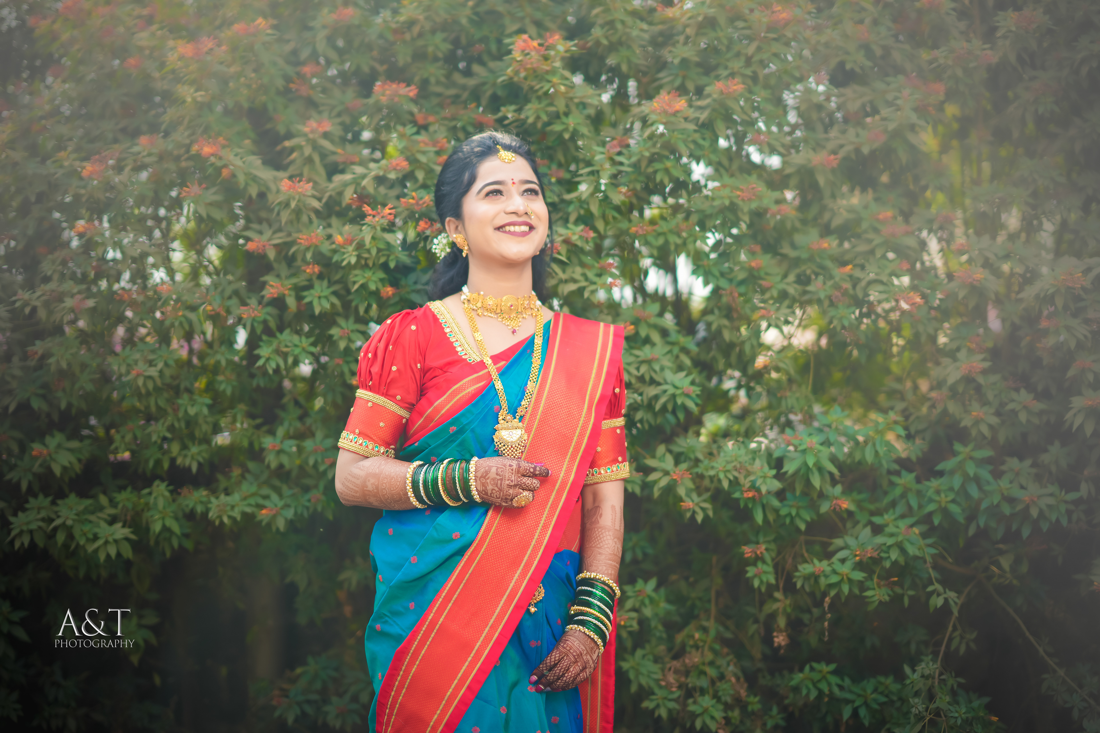 Captivating portrait of a Maharashtrian bride in a vibrant blue saree, radiating joy and beauty captured by best wedding photographer in Pune and Mumbai| A&T Photography