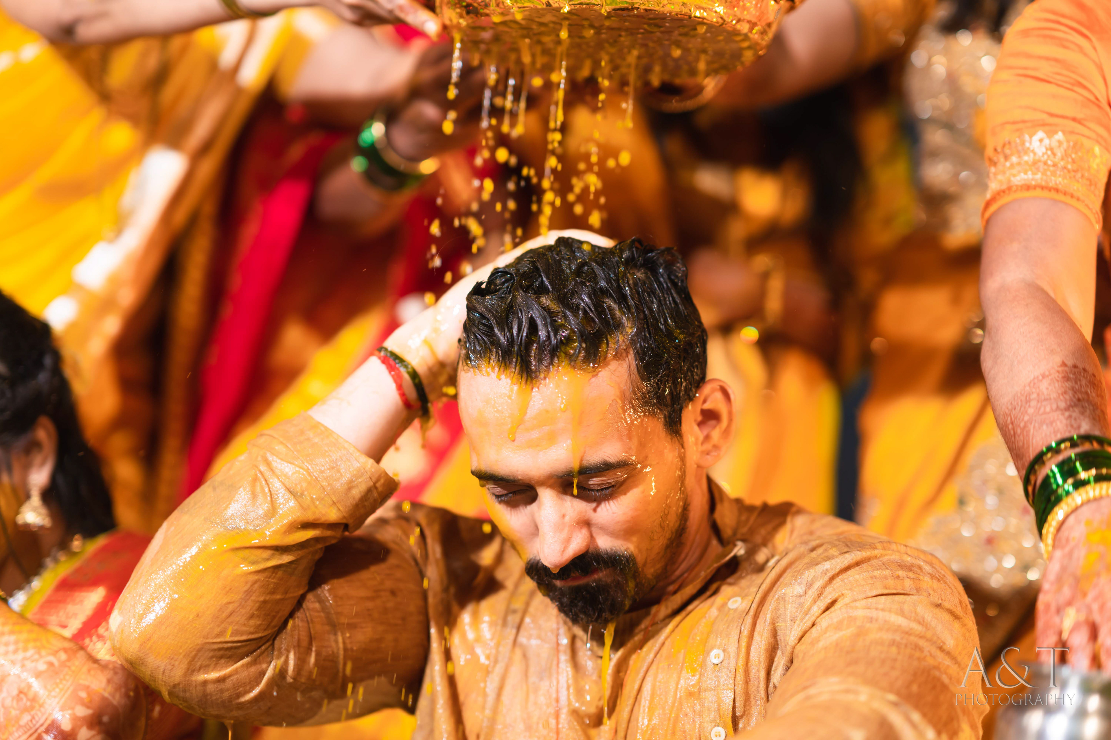 Candid Wedding photography ideas for haldi ceremony by A&T Photography