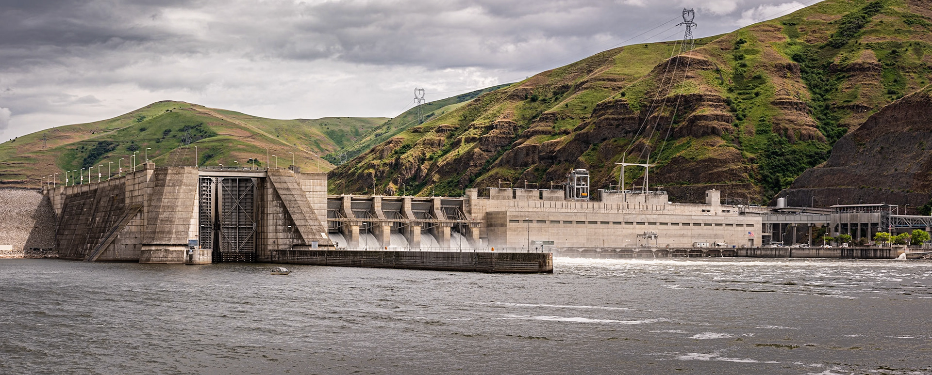 I was in the Palouse region of Washington and noticed on a map that Lower Granite Dam and Lock on the Snake River was a short drive away. It was a rainy day, so I decided the detour, even if nothing made a good image, would be interesting. I stood on the northern bank of the river for this photo, which is a panorama of three images.The bluffs on the right provide a contrasting background to the dam. They rise about 1200 feet above the river.The rated capacity of the powerhouse is 810 MW. The lock chamber has a lift of 86 feet. On the right is part of the fish chute system, which gently bypasses salmon around the dam using what is basically an oversized water-park slide.Date: 24 May 2019Location: Whitman County, Washington, United StatesOriginal resolution: 36 MPProcessing: Processed from RAW using Adobe Photoshop Lightroom Classic 10