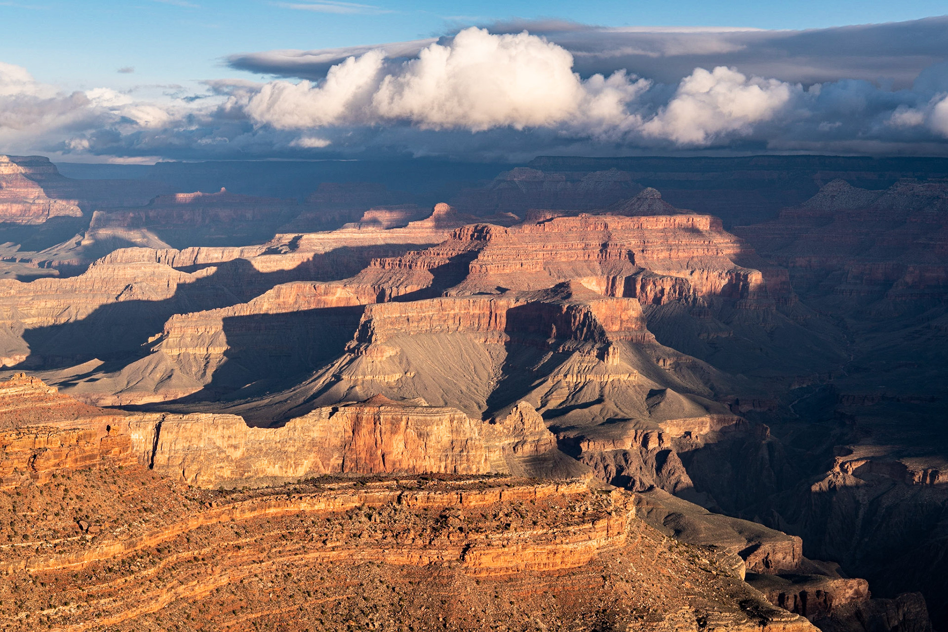 I went out for sunrise at Yavapai Point at the Grand Canyon. The skies to the east were a disappointment because of clouds, but about an hour after sunrise, sunlight began lighting up the canyon to the northwest of the point.In capturing this photo, I wanted to make sure that the cumulus cloud was centered over the canyon.Date: 18 March 2020Location: Grand Canyon National Park, Arizona, United StatesOriginal resolution: 45 MPProcessing: Processed from RAW using Adobe Photoshop Lightroom Classic 9
