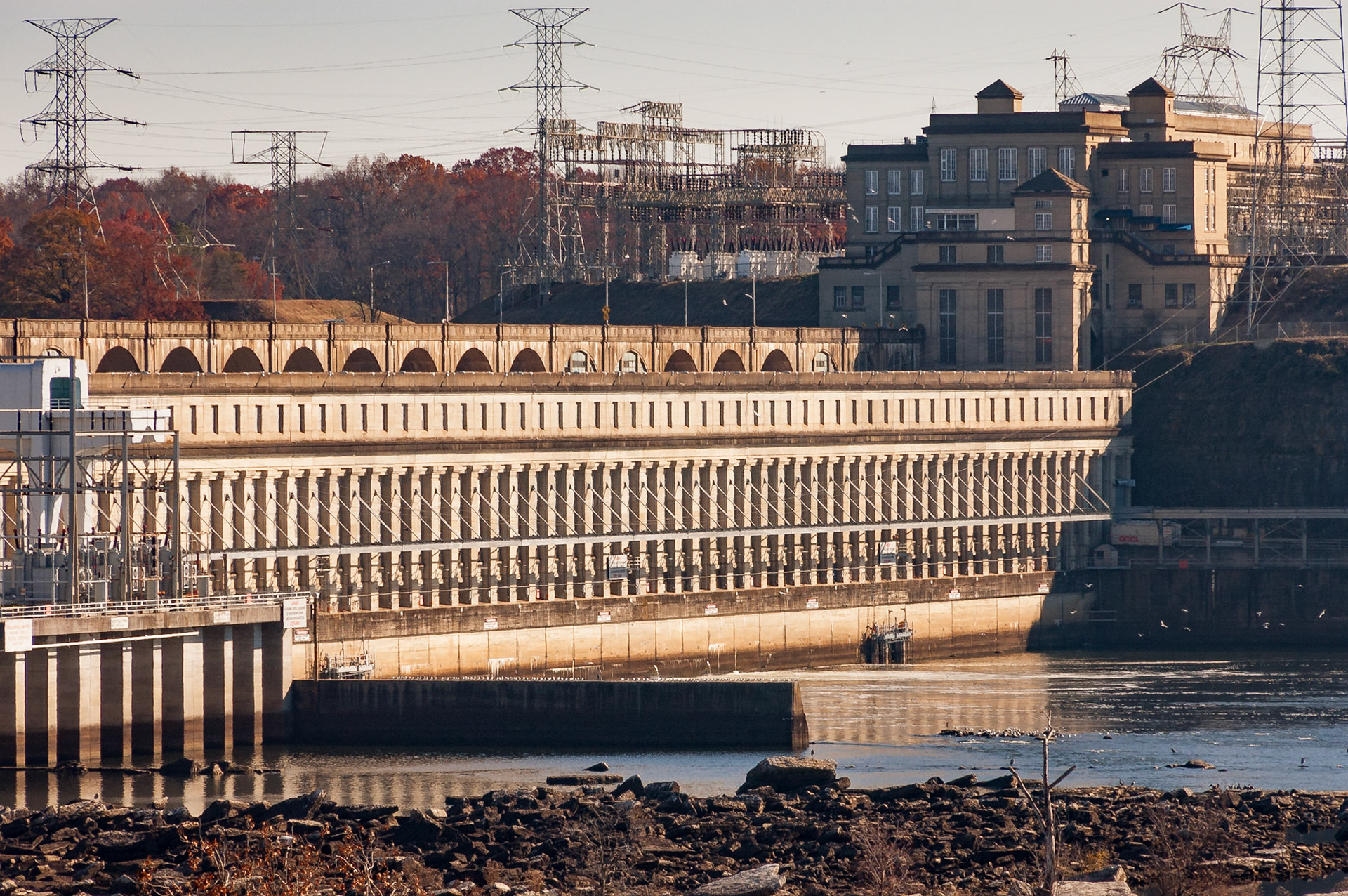 The powerhouse of the U.S. Tennessee Valley Authority's Wilson Dam spans the south end of the dam. The neoclassical style dam was the first built on the Tennessee River and dates to  its completion in 1924. It was originally built to provide power to the U.S. government's nearby nitrate plants, which were built to provide ammonium nitrate for military explosives. With the TVA Act, the dam was turned over to the TVA in 1933. The powerhouse contains 21 generators totaling 663 MW of net dependable power capacity.Date: 7 December 2008Location: Florence, Alabama, United StatesOriginal resolution: 6 MPProcessing: Processed from RAW using Adobe Photoshop Lightroom 6