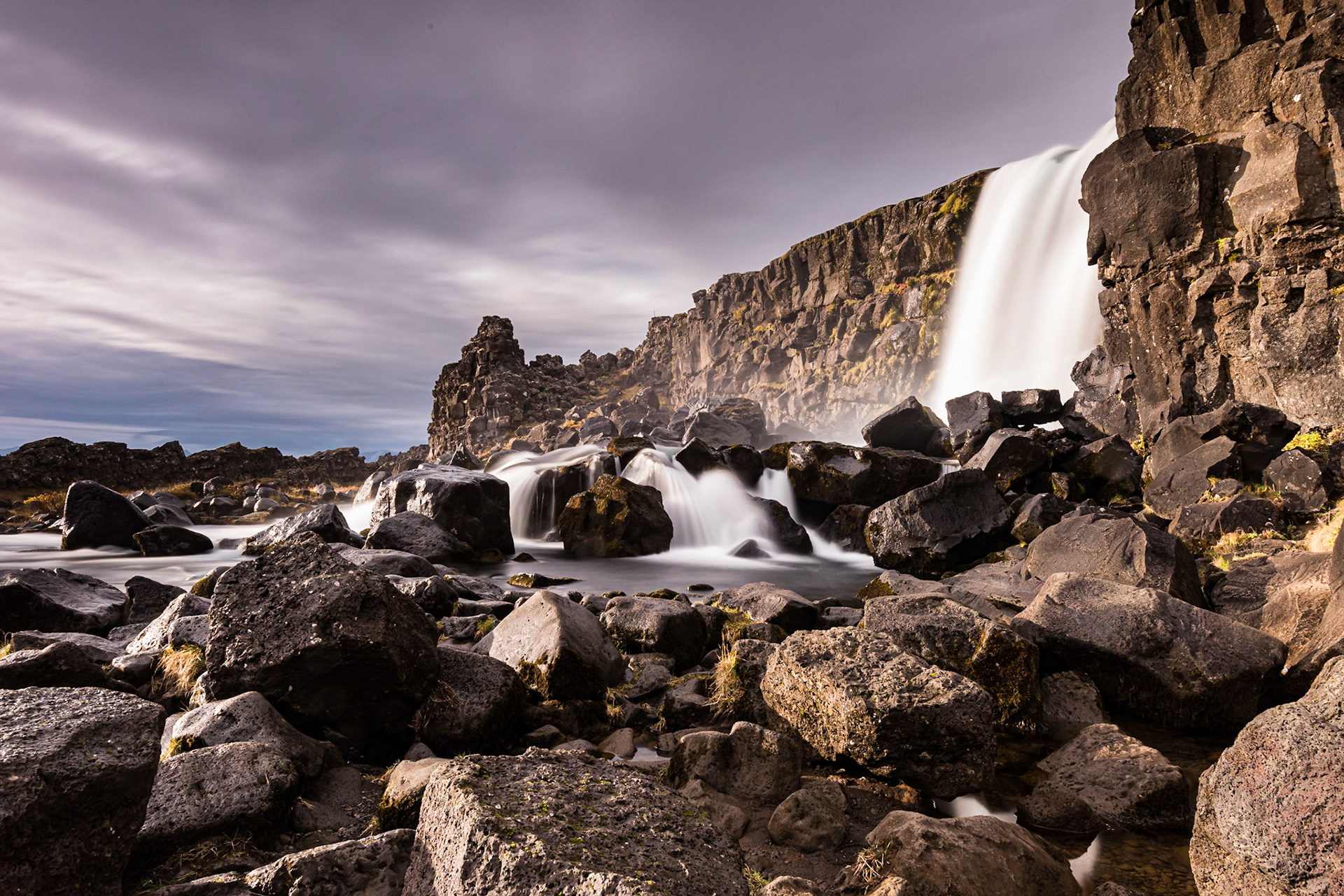I was photographing Öxarárfoss in Þingvellir National Park when the sun came out, highlighting the rocks from the left. The autumn sun in Iceland sits low on the horizon, providing a pleasing light most of the day. The waterfall is formed by the Öxará River flowing over the top of a rift wall.Date: 17 October 2017Location: Þingvellir National Park, IcelandOriginal resolution: 36 MPProcessing: Processed from RAW using Adobe Photoshop Lightroom CC