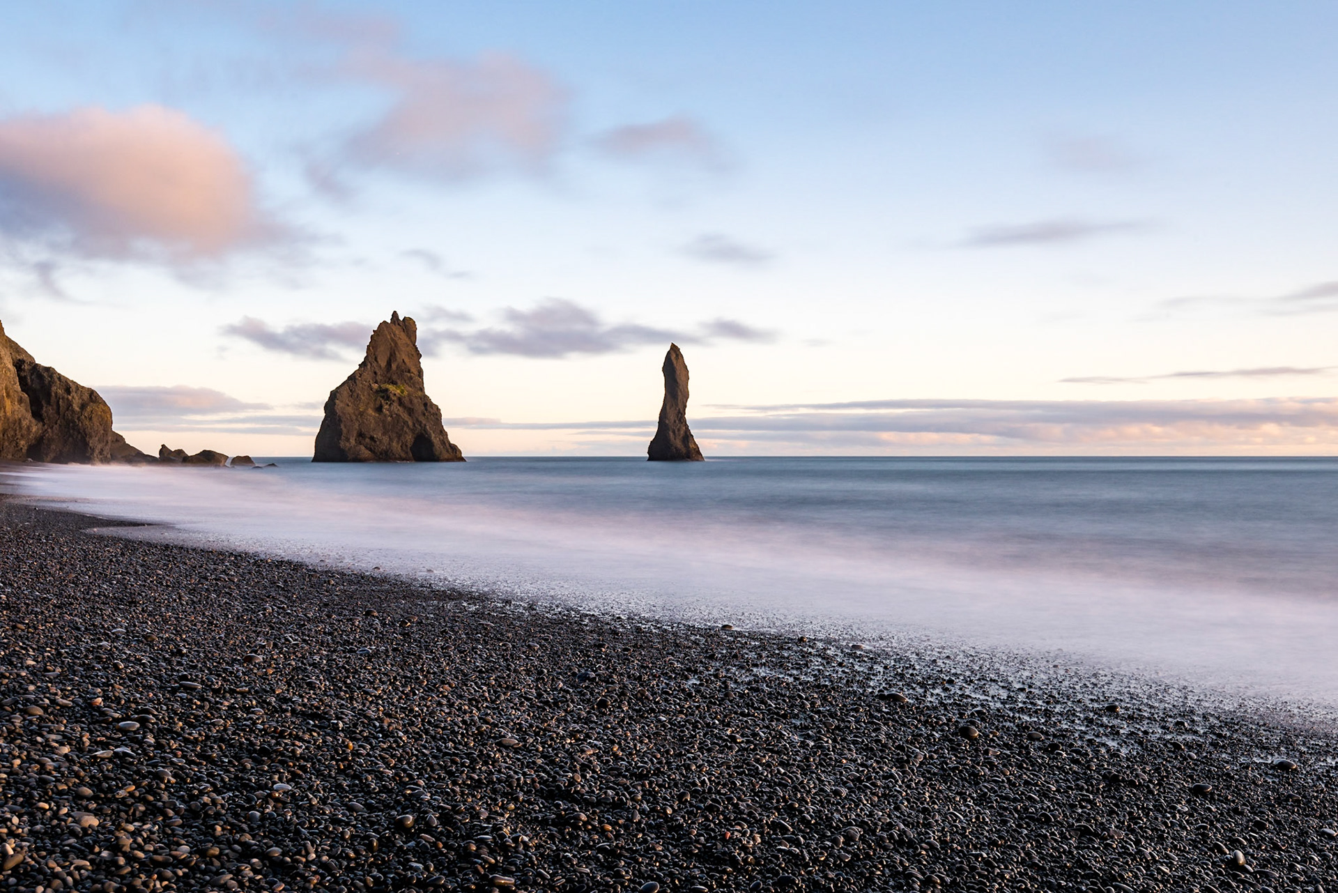 The basalt sea stacks at Reynisfjara Beach are known as Reynisdrangar. The Reynisdrangar are the subject of legends of trolls. One such legend claims two trolls dragged a three-masted ship to land unsuccessfully at Reynisfjara and when daylight broke, they turned to rock.We arrived late at Reynisfjara late in the afternoon, and the Reynisdrangar are the first scene I photographed. To smooth the waves, I used a ten-stop neutral density filter.Date: 16 October 2017Location: Vik, IcelandOriginal resolution: 36 MPProcessing: Processed from RAW using Adobe Photoshop Lightroom 6