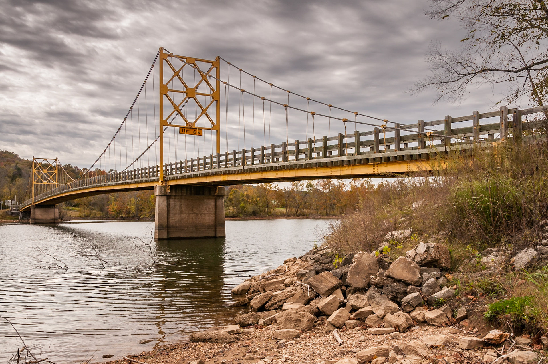 The Beaver Bridge, known as the Little Golden Gate of Arkansas, crosses the White River at Beaver. It is the only suspension bridge left in Arkansas. Built in 1949, it still has a wooden deck and railings.Date: 27 October 2010Location: Beaver, Arkansas, United StatesOriginal resolution: 12 MPProcessing: Processed from RAW using Adobe Photoshop Lightroom 6