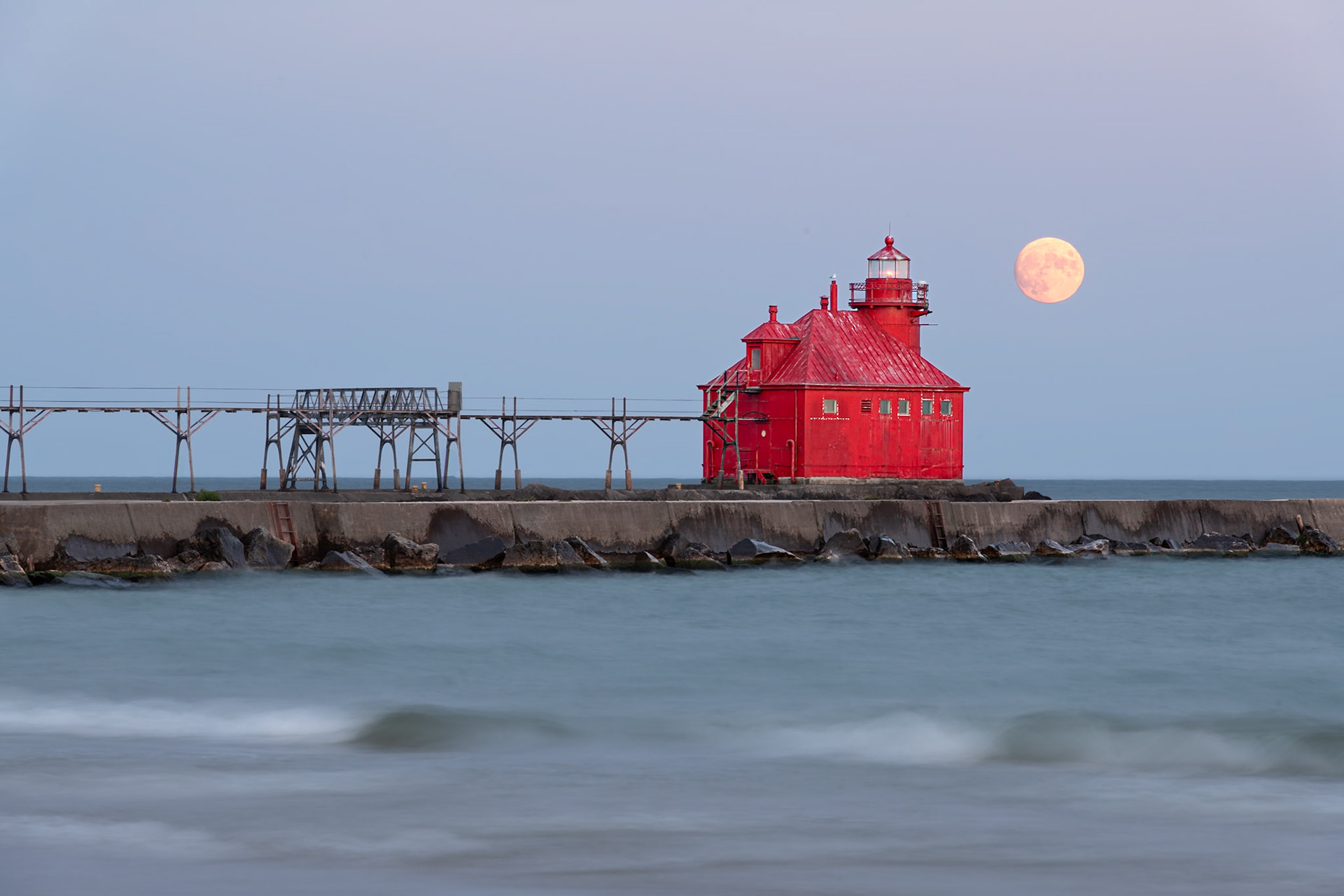 I knew I wanted to photograph this schoolhouse-style lighthouse at the end of the Sturgeon Bay Ship Canal on my trip to Door County. Luck was with me when I realized that the sky would be clear and moonrise of the full moon would be at dusk on Otcober 8th. I lined up this shot from the beach at Sturgeon Bay Ship Canal Nature Preserve. I intentionally underexposed so that I could preserve some details in the moon. | Date: 8 October 2022 | Location: Sturgeon Bay, Wisconsin, United States | Original resolution: 45MP | Processing: Processed from RAW using Adobe Photoshop Lightroom Classic 12