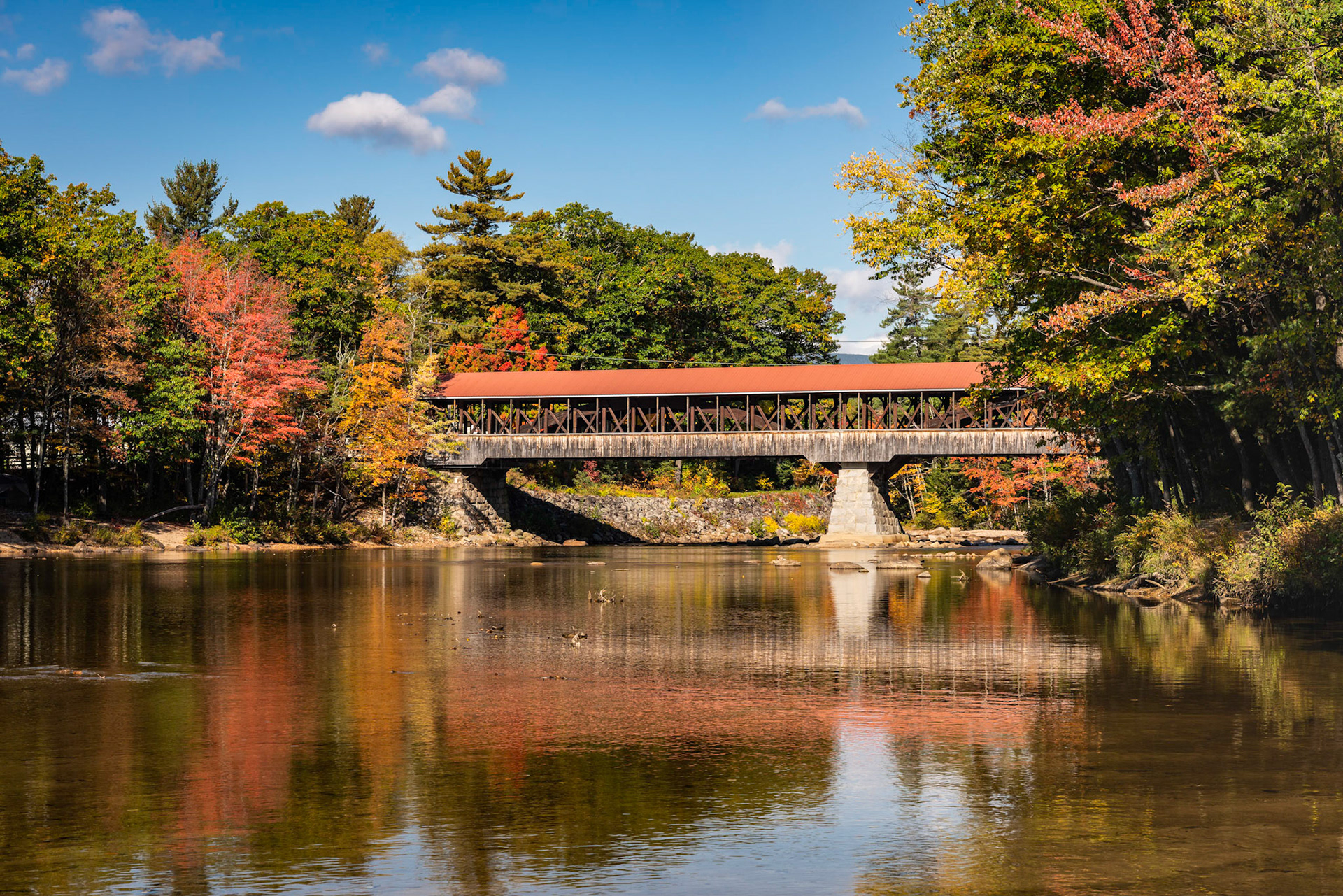 I've photographed the Saco River covered bridge three times over the years. This is the first time that I had a sunny day so that the sky looked nice. The bridge was originally built in 1890 and continues to carry traffic. I walked downstream from the bridge and took the photo from near the Highway 16 bridge.Date: 10 October 2018Location: Conway, New Hampshire, United StatesOriginal resolution: 36 MPProcessing: Processed from RAW using Adobe Photoshop Lightroom 6