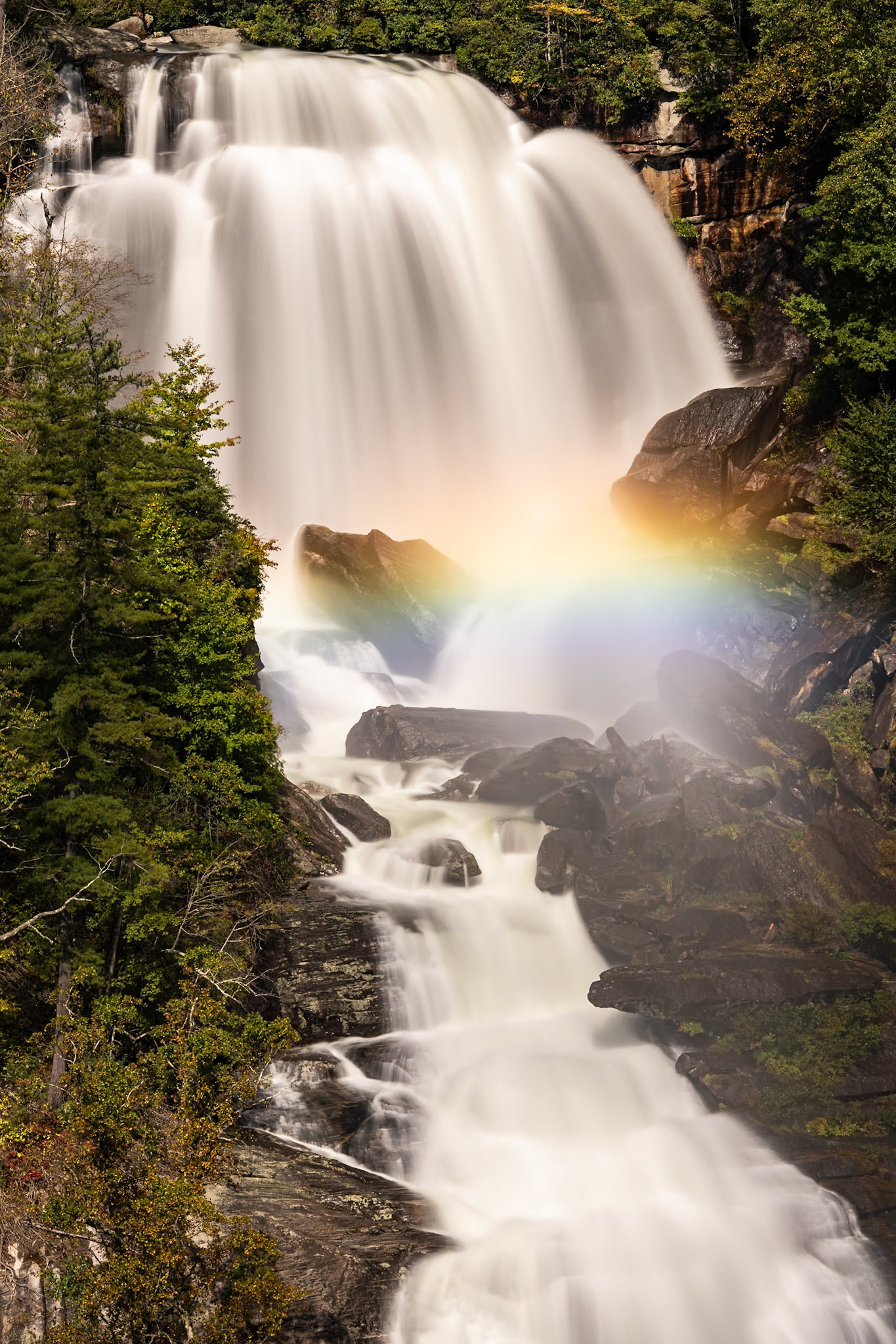 Whitewater Falls is the tallest falls in the Eastern U.S. We had been here just a few months before when the water flow was much lower. Recent rains had swollen the river, and the falls were thundering.The rainbow formed in the upper section of the falls whenvever the sun peaked through the clouds.Date: 9 October 2021Location: Transylvania County, North Carolina, United StatesOriginal resolution: 45 MPProcessing: Processed from RAW using Adobe Photoshop Lightroom Classic 11