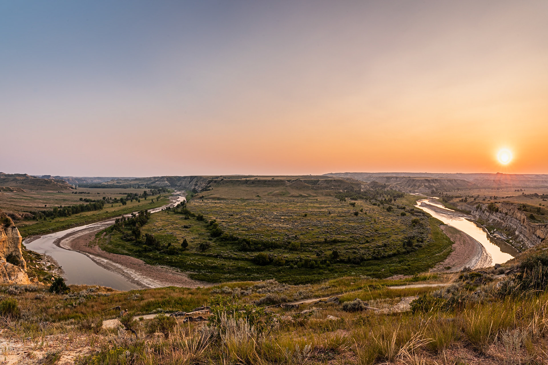 This was a tough image to create. From the bluff, 14 mm wasn't quite wide enough to capture the entire bend, so I took two photos at 14 mm and stitched them together. The curvature of the river isn't quite true, but the view still looks realistic.Date: 10 August 2018Location: Theodore Roosevelt National Park, North Dakota, United StatesOriginal resolution: 36 MPProcessing: Processed from RAW using Adobe Photoshop Lightroom Classic CC 7