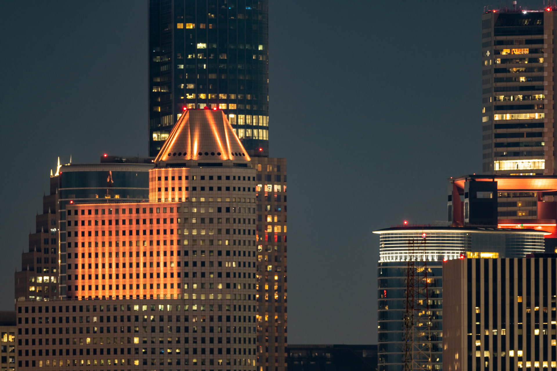 I was photographing the Blue Moon from the roof of a parking garage in Rice Village when I decided to try to photograph downtown. I used a 500 mm lens with 1.4x teleconverter on a crop sensor, so the 35 mm equivalent is 1050 mm.The building to the left with the truncated pyramid on top is 1600 Smith Street, which is partially leased to Chevron and was once the headquarters of Continental Airlines. The tallest building behind it is Wells Fargo Plaza.The rounded building to the right is the Chevron building at 1500 Louisiana Street, which was formerly the Enron Building. In front of it sits the KBR building. The tallest building behind it is the JPMorgan Chase building, the tallest building in Houston.Date: 31October 2020Location: Houston, Texas, United StatesOriginal resolution: 20 MPProcessing: Processed from RAW using Adobe Photoshop Lightroom Classic 9