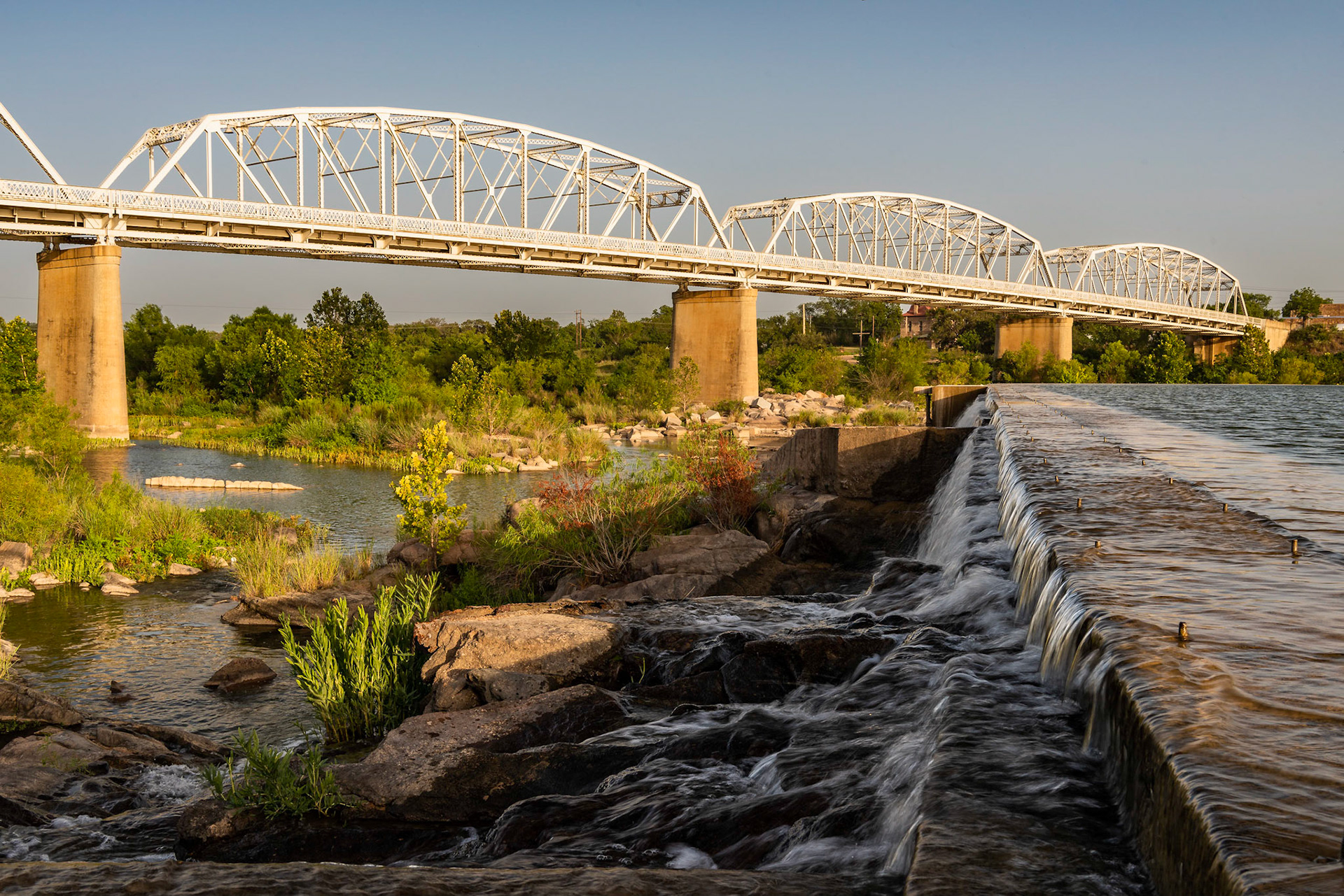 The Roy B. Inks Bridge over the Llano River at the town of Llano is a steel Parker through-truss bridge. It was built in 1936 to replace the bridge destroyed by a flood in 1935. The dam to the right backs up a small recreational lake but provides no other function.Date: 15 July 2018Location: Llano, Texas, United StatesOriginal resolution: 36 MPProcessing: Processed from RAW using Adobe Photoshop Lightroom 6