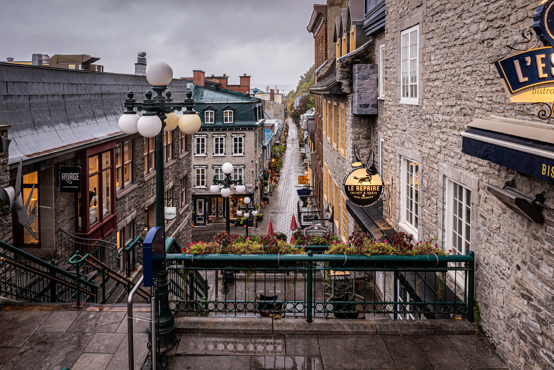 The Escalier Casse-Cou, known as the Breakneck Steps in English, descend from Côte de la Montagne to Rue du Petit Champlain in Vieux Québec. The stairs at this location date to 1635. A number of restaurants and shops are located along the stairs.  We got up early on a rainy Sunday to photograph them before the tourists hordes descended on the area.Date: 7 October 2018Location: Québec, Québec, CanadaOriginal resolution: 36 MPProcessing: Processed from RAW using Adobe Photoshop Lightroom Classic CC 7.5