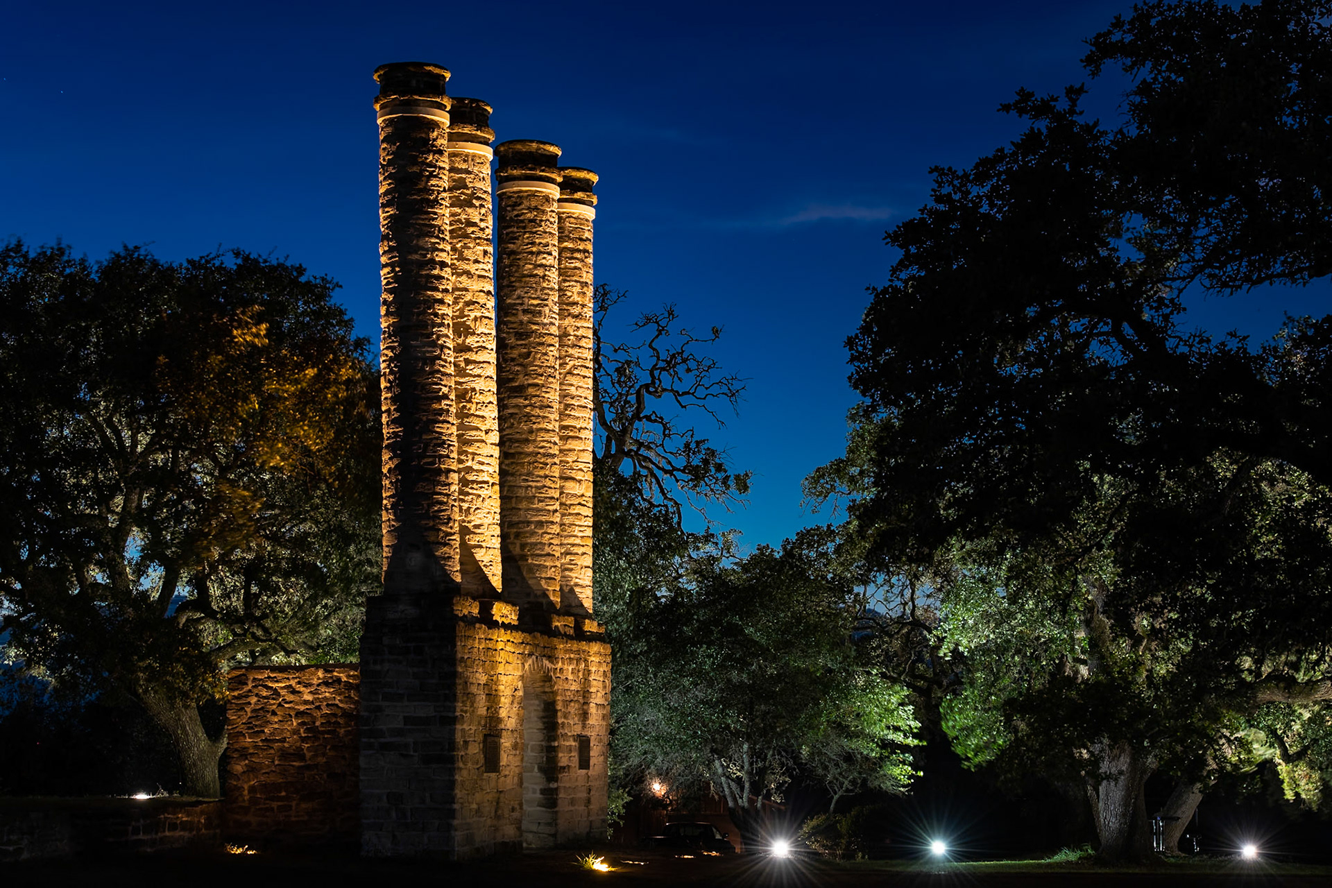 The columns at Old Baylor Park are lit at night by an array of spotlights, as are some of the live oaks. I set up this shot so that the live oak on the right gives some balance to the columns on the left.Date: 24 July 2020Location: Independence, Texas, United StatesOriginal resolution: 45 MPProcessing: Processed from RAW using Adobe Photoshop Lightroom Classic 9