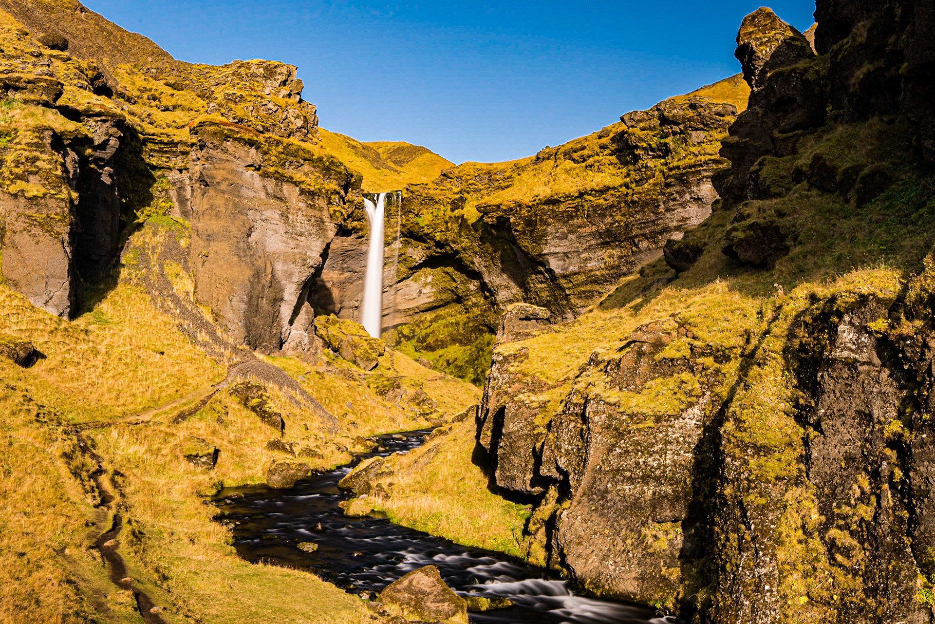 Kvernufoss sits near the more famous Skógarfoss waterfall, but at the end of a short trail. I stopped and took this photo on the way out of the canyon to take advantage of the lighting of the afternoon, autumn sun.Date: 16 October 2017Location: Skógar, IcelandOriginal resolution: 36 MPProcessing: Processed from RAW using Adobe Photoshop Lightroom 6