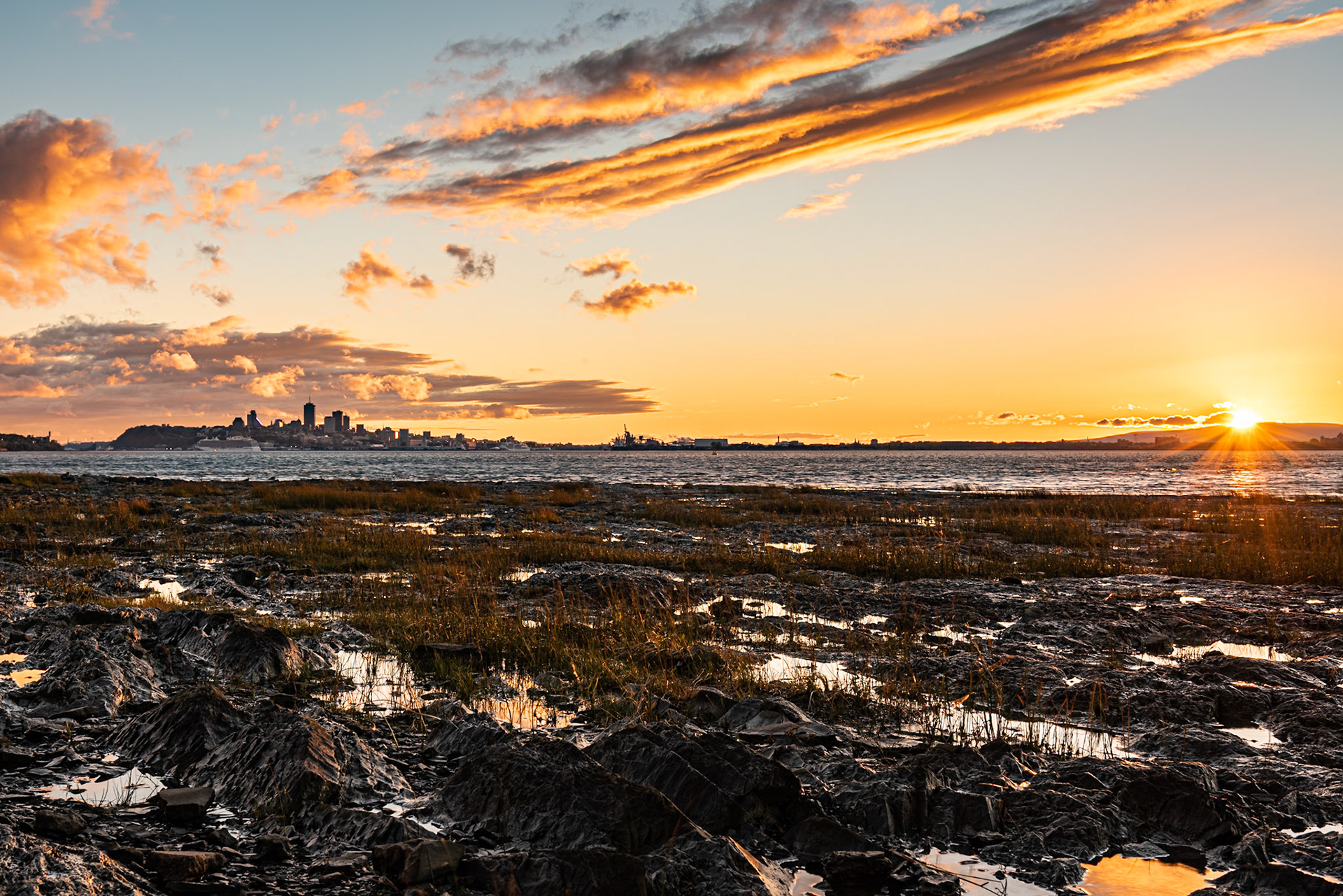 We had been touring the Île D'Orleans all day in an occasional drizzle. I kept watching the weather forecast, which promised clearing around sunset. Sure enough, the clouds did clear, and we watched this magnificent sunset from Sainte-Petronille over the Saint Lawrence.Date: 4 October 2018Location: Sainte-Pétronille, Québec, CanadaOriginal resolution: 36 MPProcessing: Processed from RAW using Adobe Photoshop Lightroom Classic CC 7