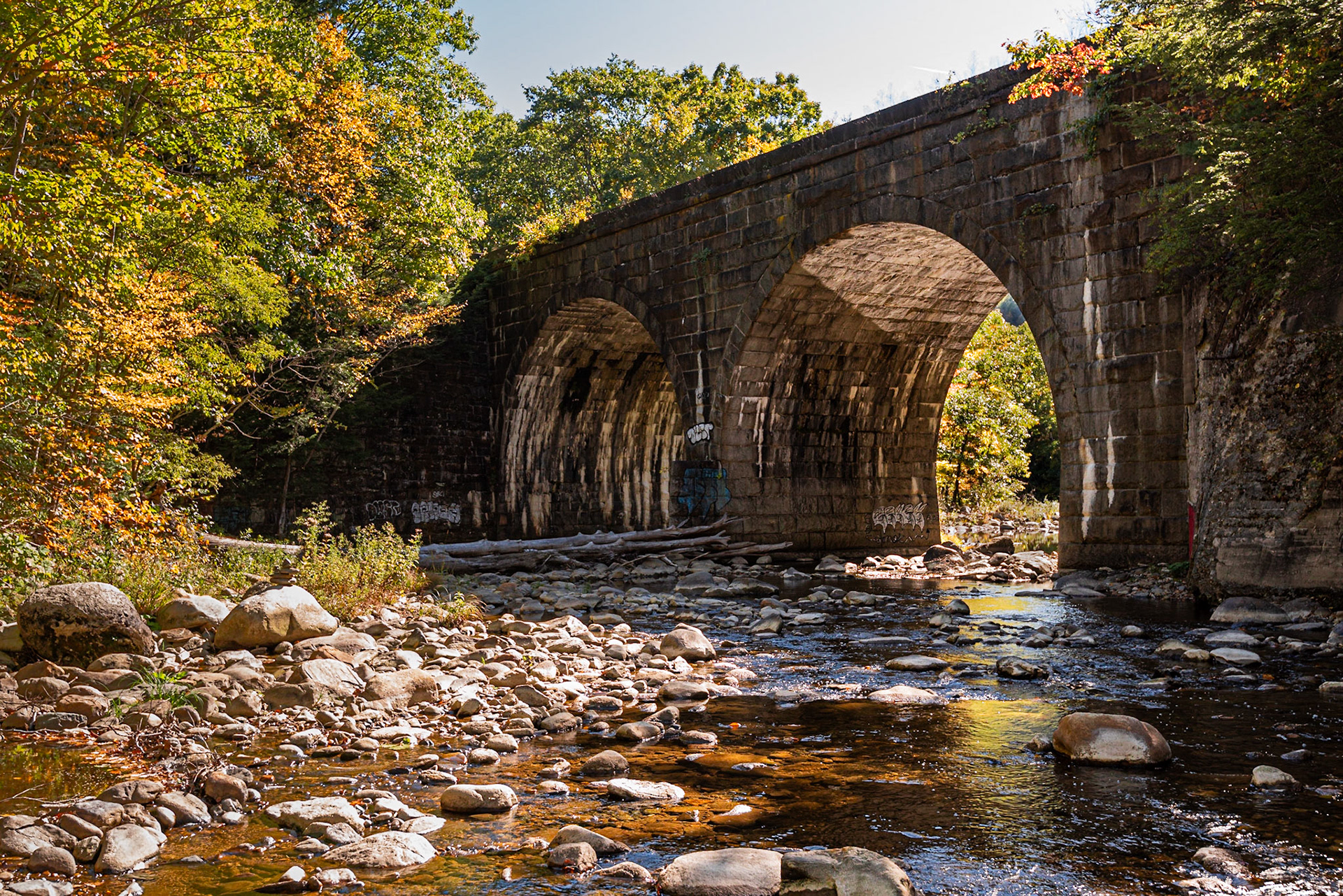 The Keystone Arch Bridges Trail follows the Westfield River as it crisscrosses a double-tracked section of the CSX railroad., with both river and railroad passing through an 800-ft gorge. This double arch bridge, dating to the 1840s, is just off the trailhead and is the easiest to access. | 11 October 2016 | Chester, Massachusetts, United States | Nikon D810 | 36 MP | Processed from RAW using Adobe Photoshop Lightroom CC 2015