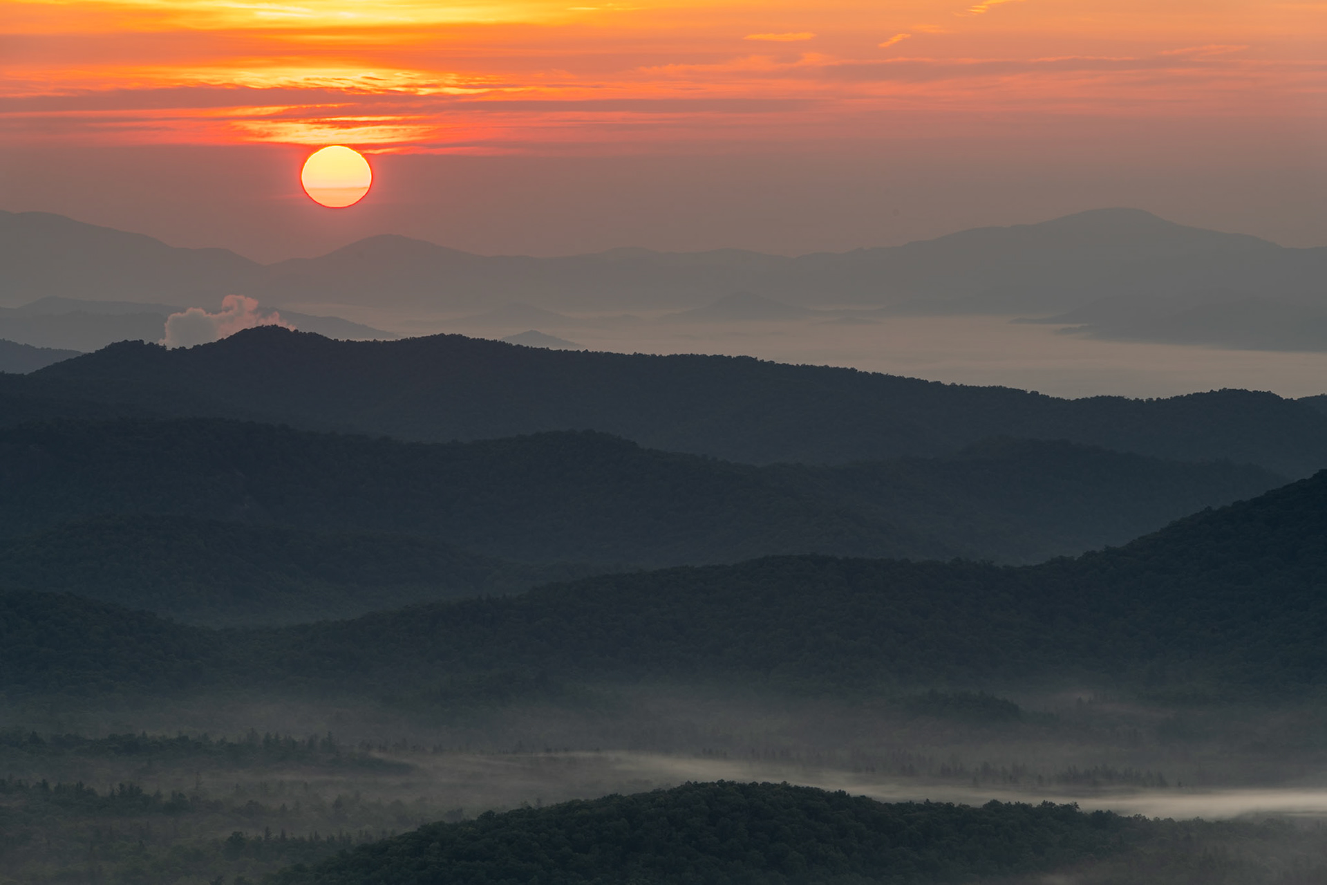 I got up at 5:00 a.m. to drive up to the Pounding Mill Overlook on the Blue Ridge Parkway to photograph the sunrise. The various ridges in the Pisgah National Forest create a sense of depth in the photo.Date: 16 July 2021Location: Transylvania County, North Carolina, United StatesOriginal resolution: 45 MPProcessing: Processed from RAW using Adobe Photoshop Lightroom Classic 10