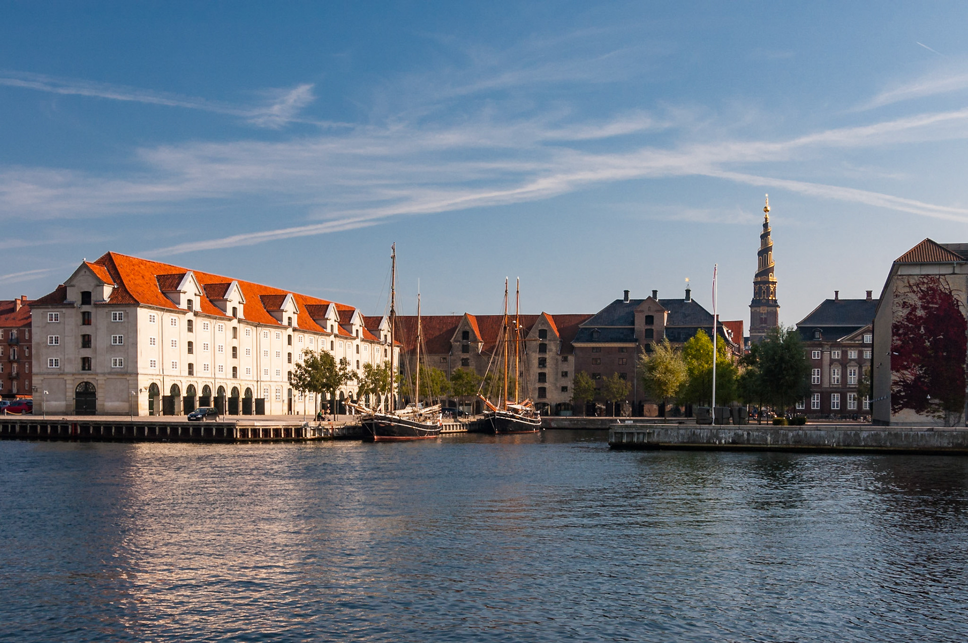 This small harbor sits in Christianshavn, a group of man-made islands in the Inner Harbor of Copenhagen. The Danish Asia Company was once located here. The Church of Our Savior (Vor Frelsers Kirke), famous for its helical spire, is in the background.Date: 24 September 2007Location: Copenhagen, DenmarkOriginal resolution: 6 MPProcessing: Processed from RAW using Adobe Photoshop Lightroom Classic CC 7