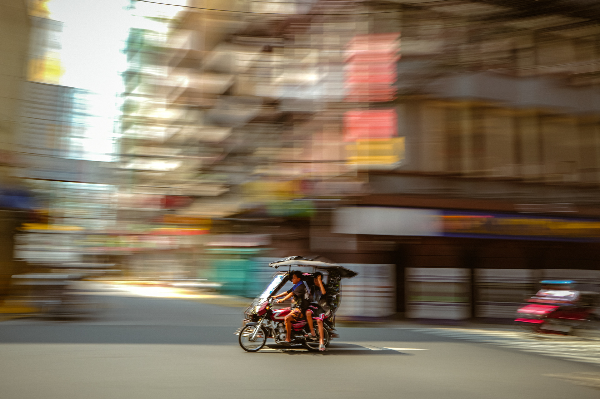 Tricycle in motion on a Manila street, captured during a one-week photo journey through the Philippines in March 2025