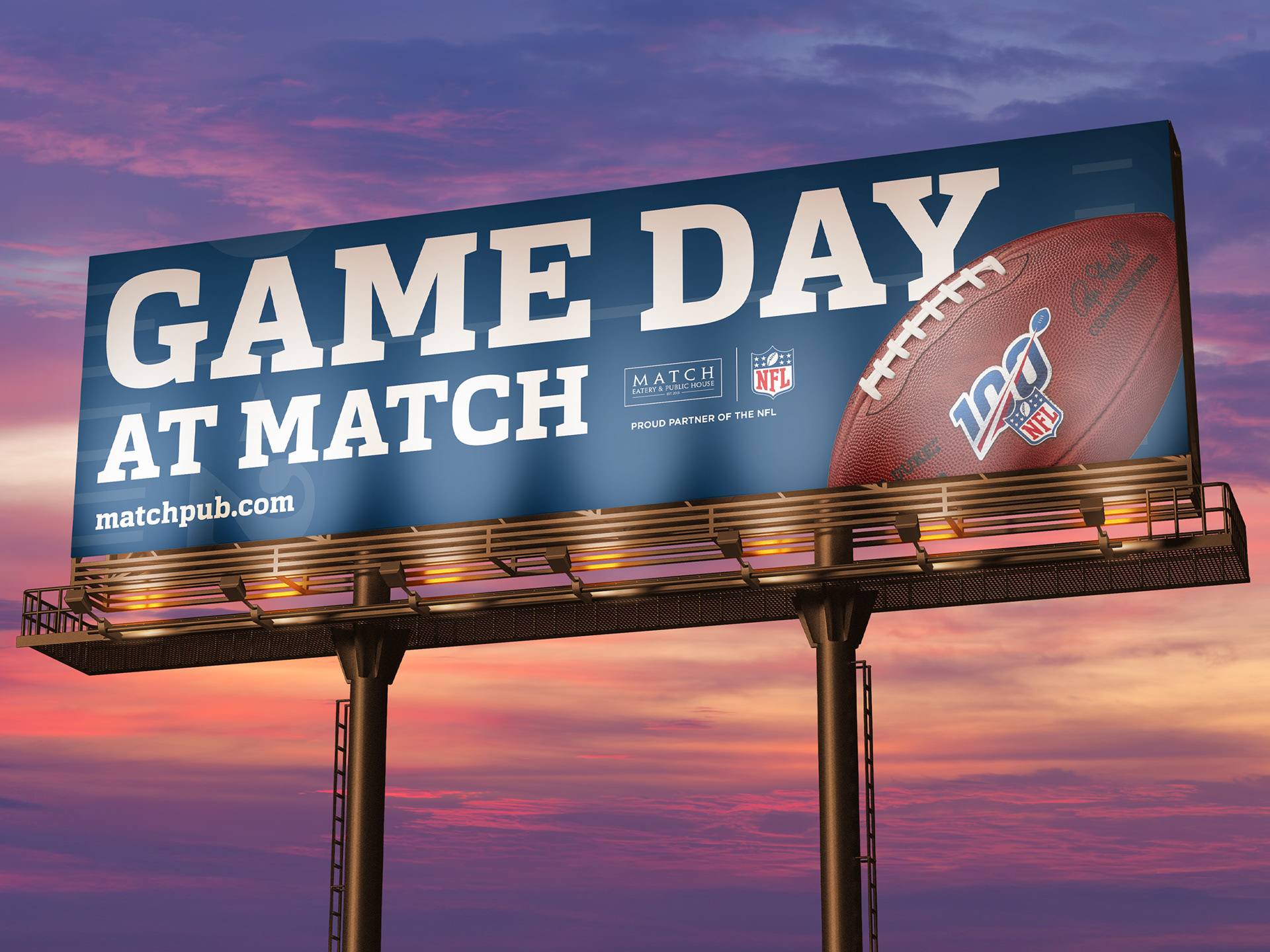 "Game Day at Match" billboard at sunset featuring an NFL 100th-season commemorative football and matchpub.com URL