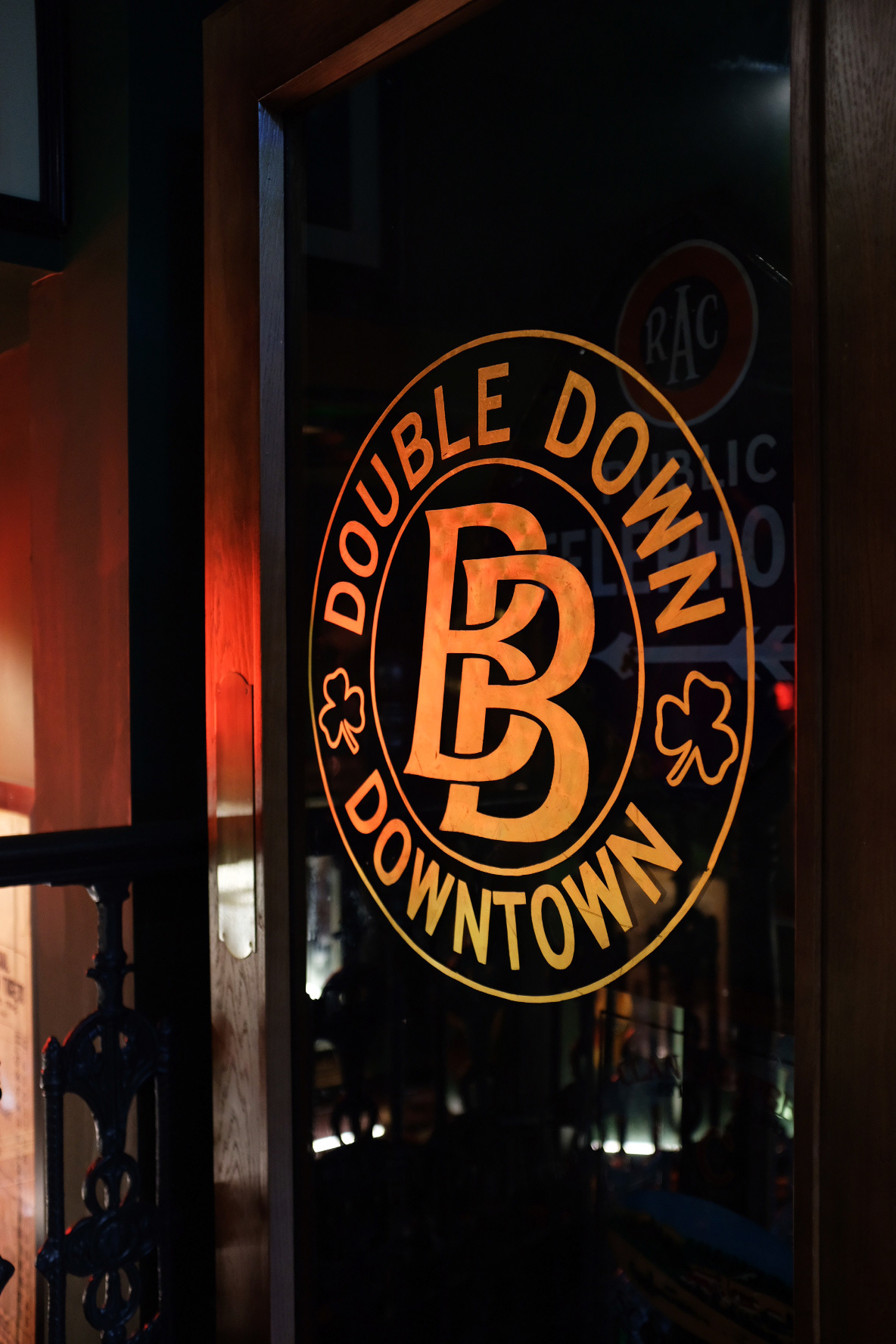 Gold leaf logo on interior doorway, leading to 'Downtown' late night area