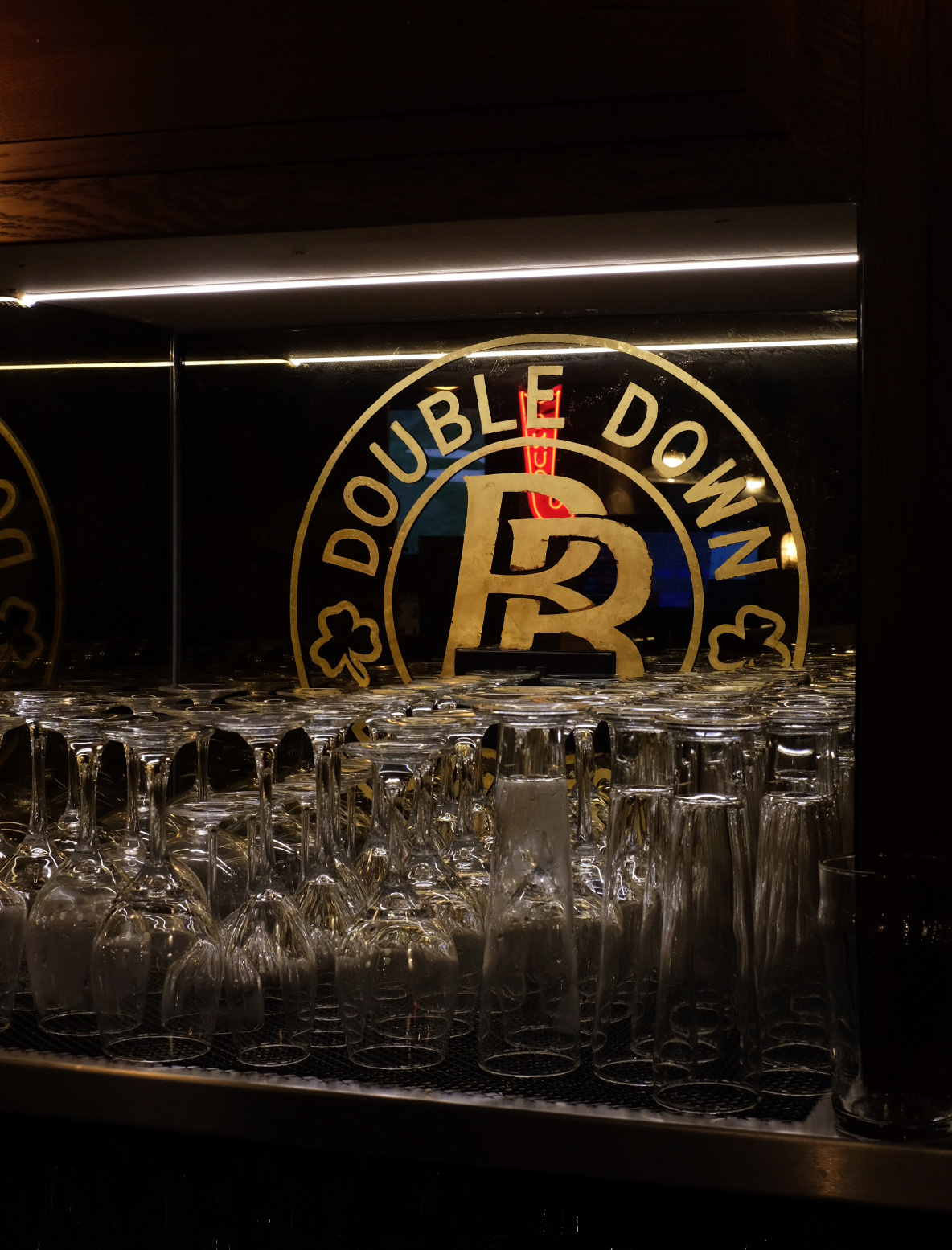 Aged gold logos on back of bar mirrors
