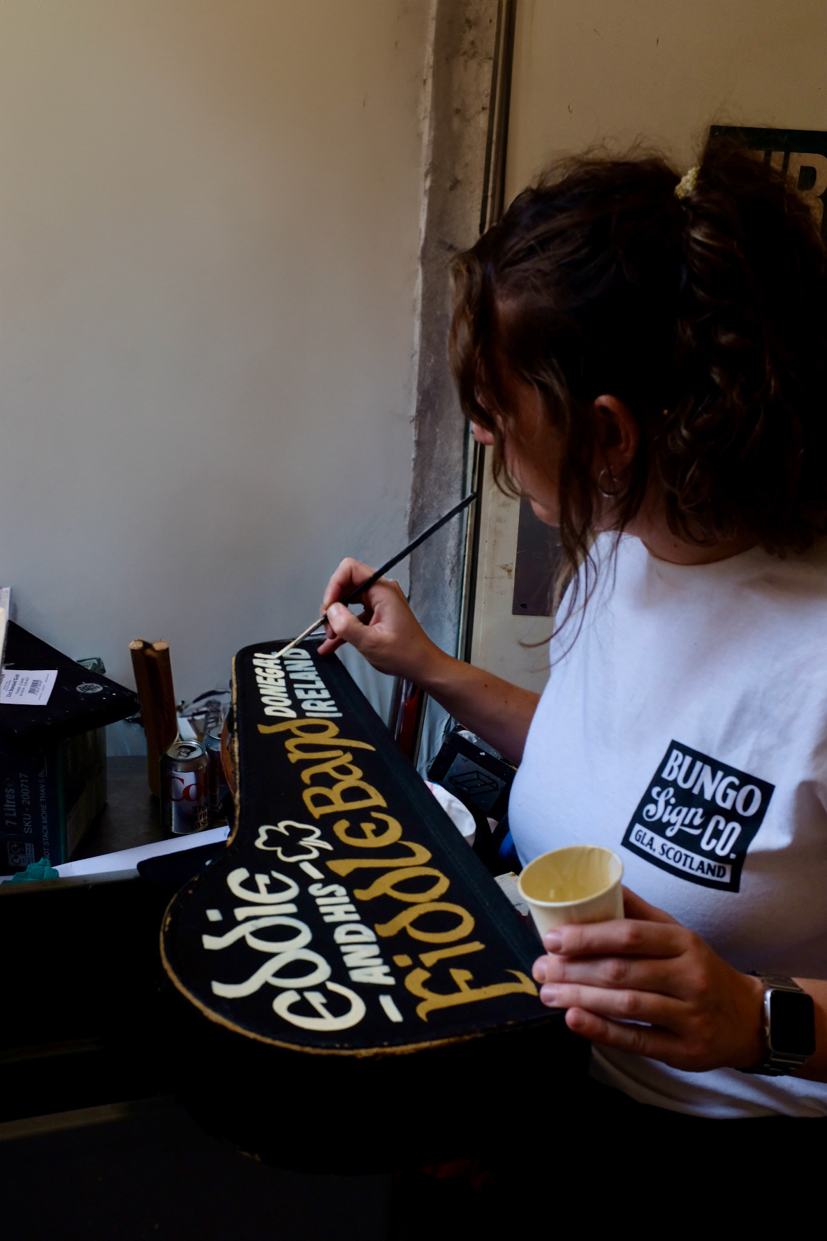 Rachel painting and gilding an antique fiddle case