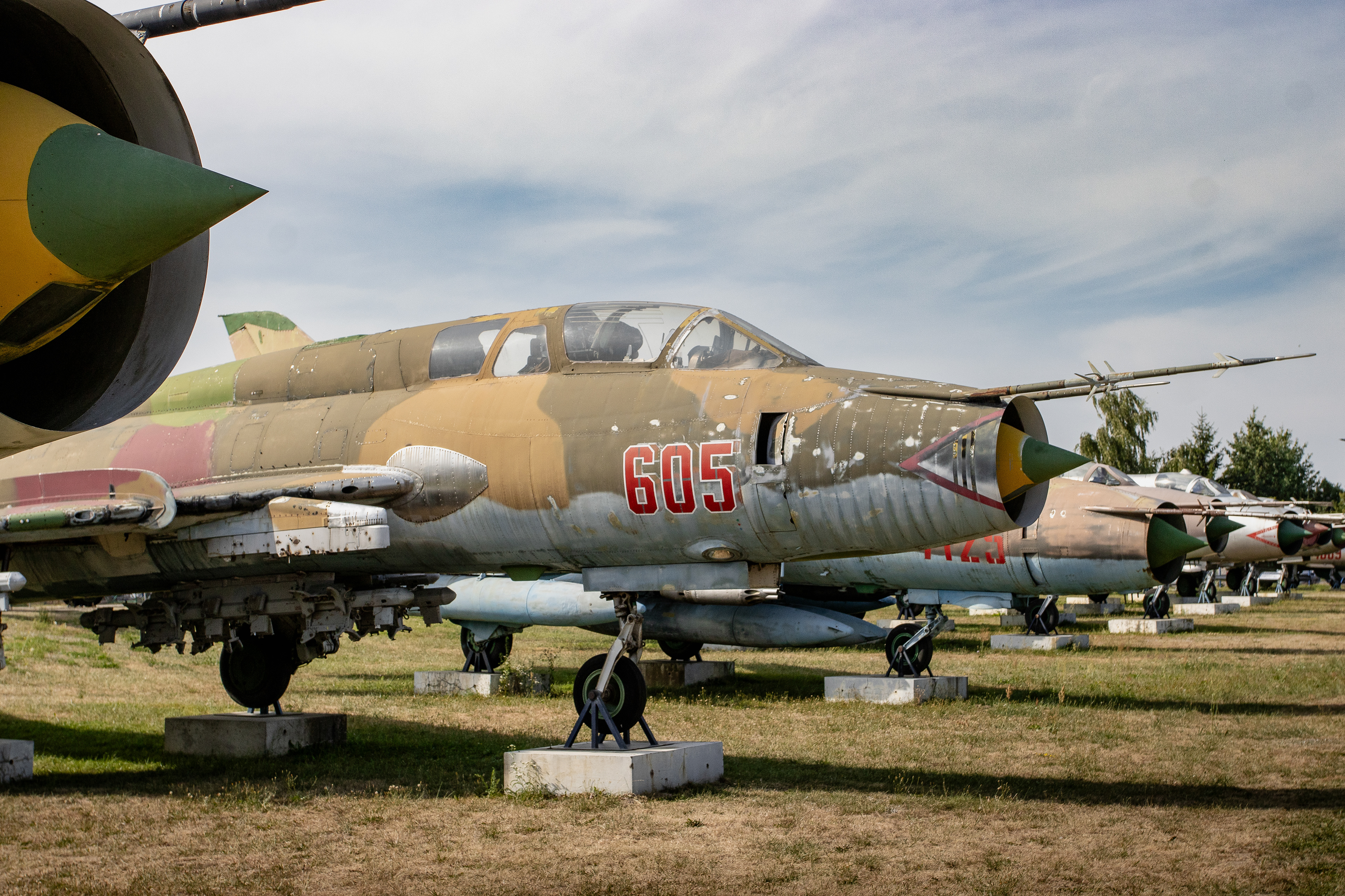 A row of fighter jets at the Muzeum Sił Powietrznych w Dęblinie (Aviation Museum in Deblin), Poland. Starring in the front is the Sukhoi Su-22UM3K, NATO code name Fitter, nr 605 that served the Polish Air Force from Swidwin Air Base.,