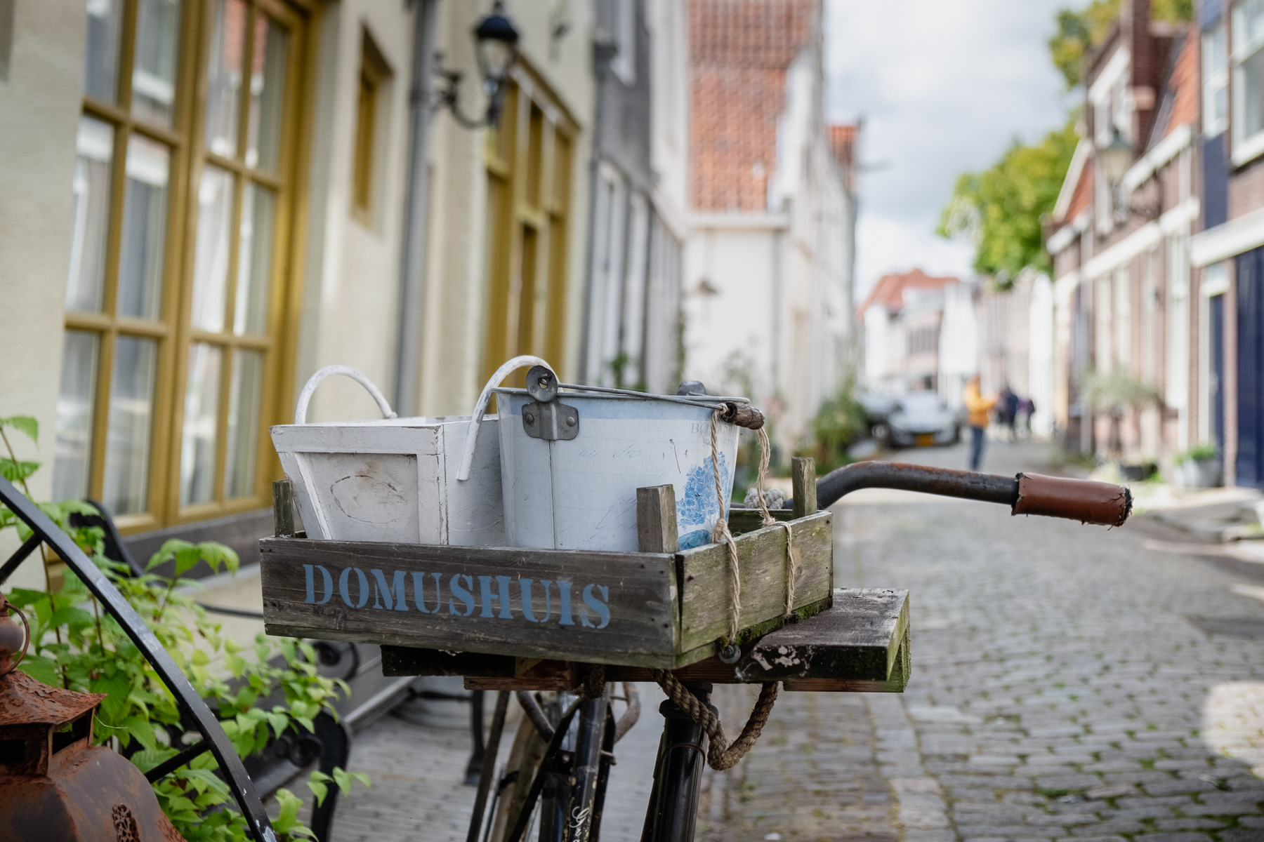 Bicycle with Domushuis written on it, Zierikzee, August 2023.