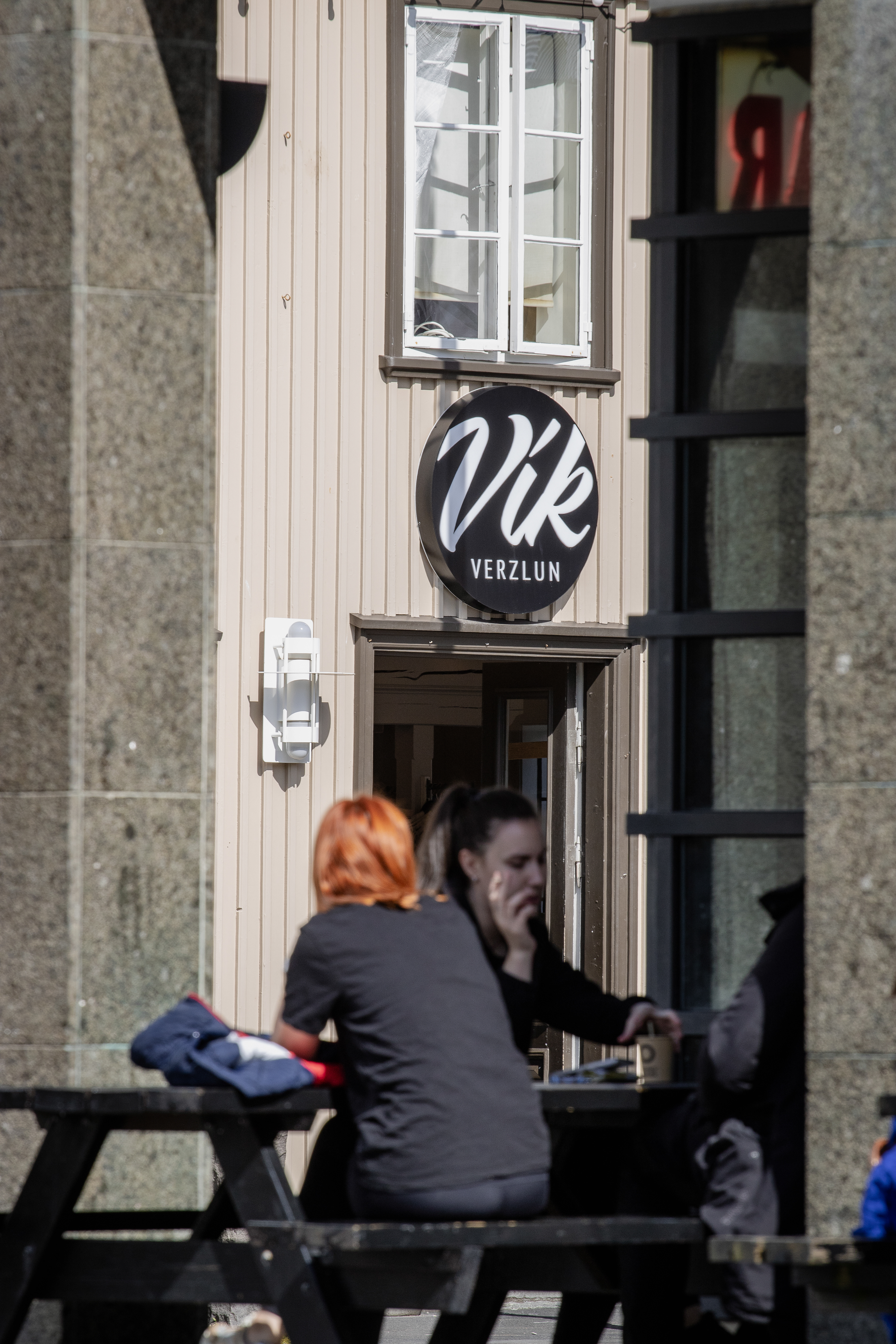 Two women taking a break near the Vik Verzlun clothing store.