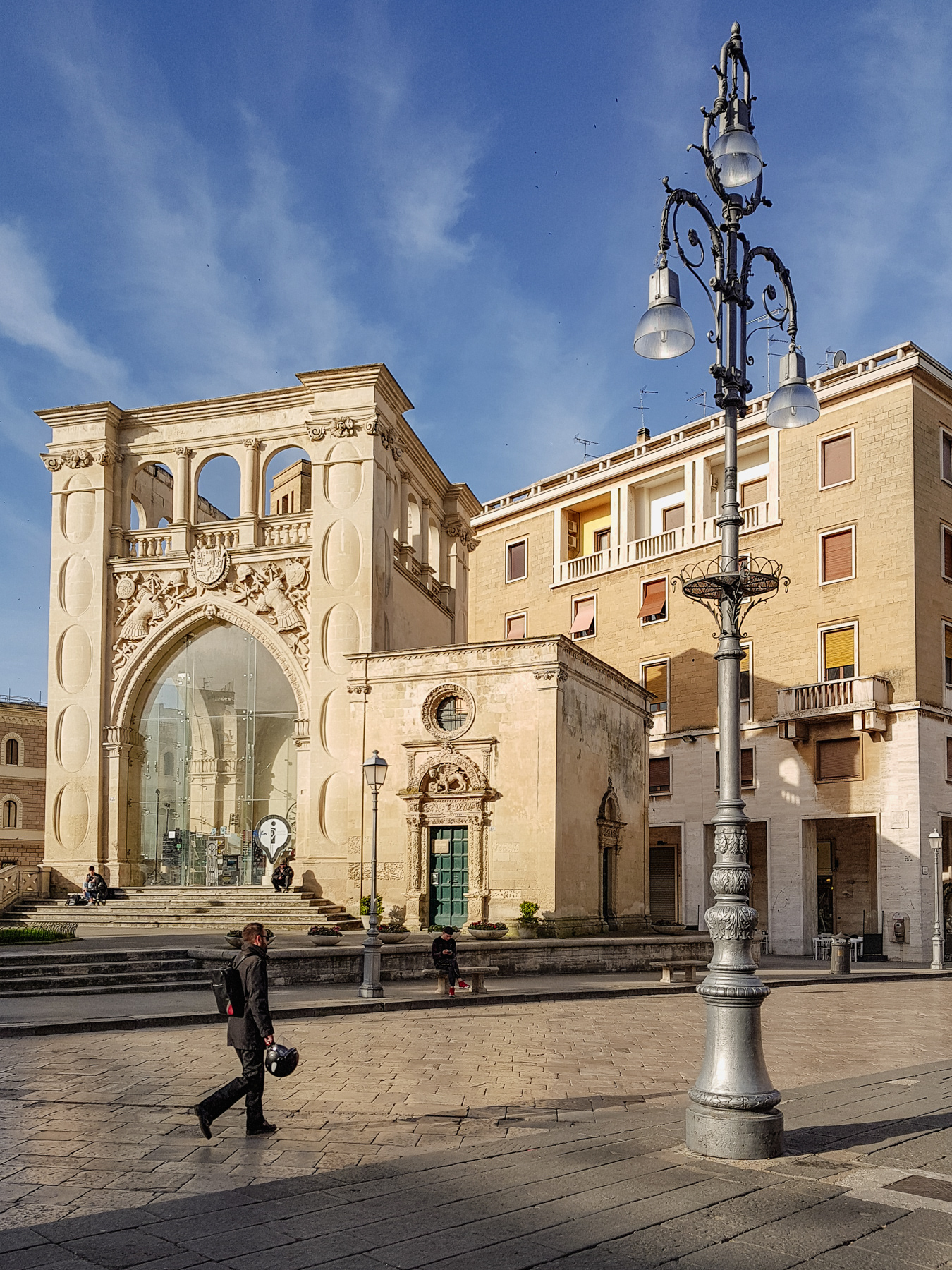 At the forefront two buildings connected: the palace (Palazzo del Seggio-Sedile) and the former church of San Marco. 
