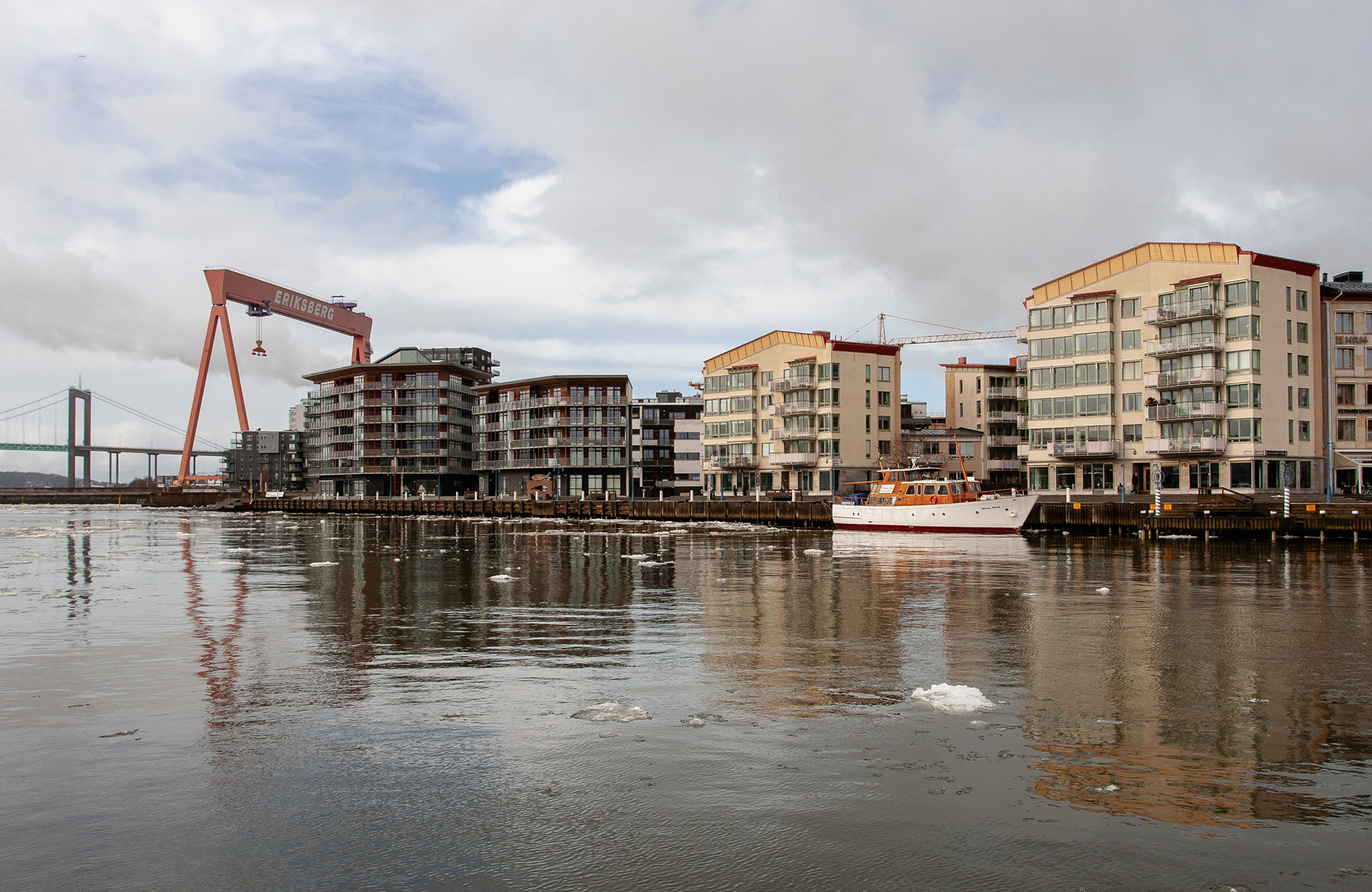 The Eriksberg crane and residential buildings, with further away the "Golden Gate Bridge" of Gothenburg: Älvsborgsbron. February 2012.