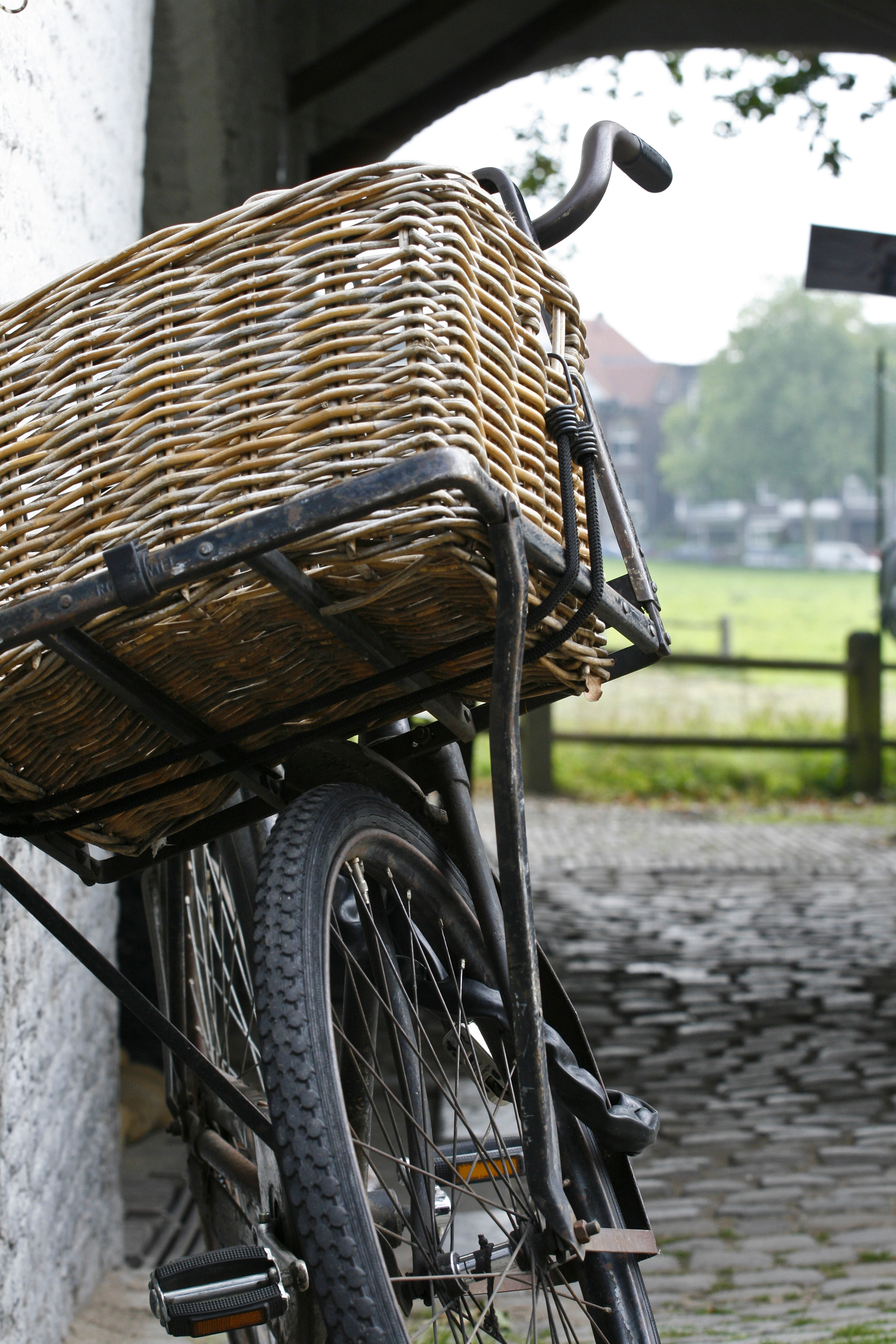 A bicycle with basket near the old water mill.