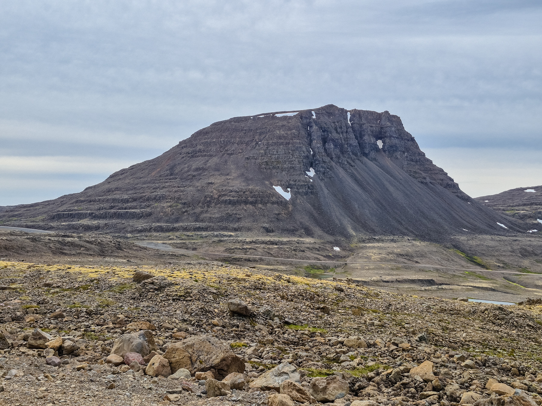 A dramatically shaped mountain marks the entrance to Road 612 (spot it in front for perspective), a stunning scenic way to go west.