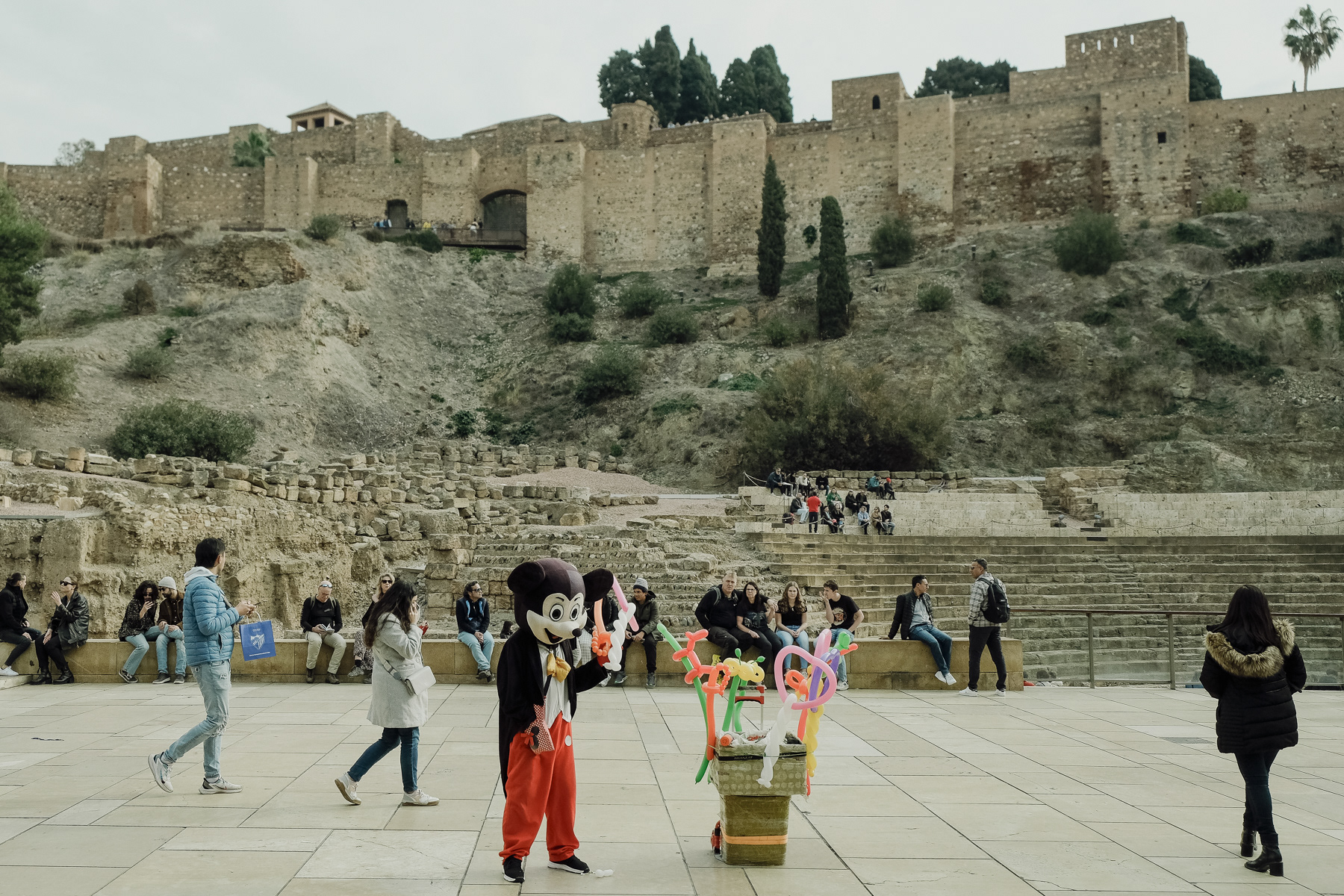The square in front of the Roman amphitheatre with tourist trap Micky Mouse trying to sell balloons shaped in different forms.