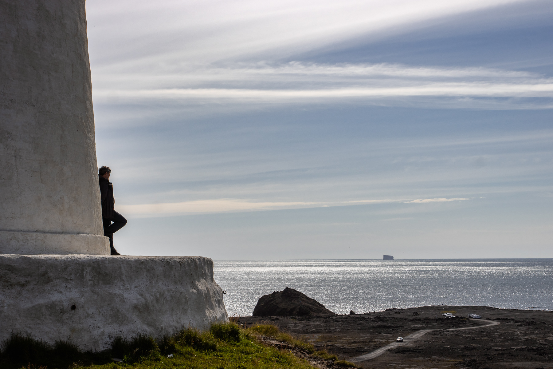 The Reykjanes Lighthouse. Reykjanes peninsula (Suðurnes), Iceland. With a view over the ocean and a rock far away.