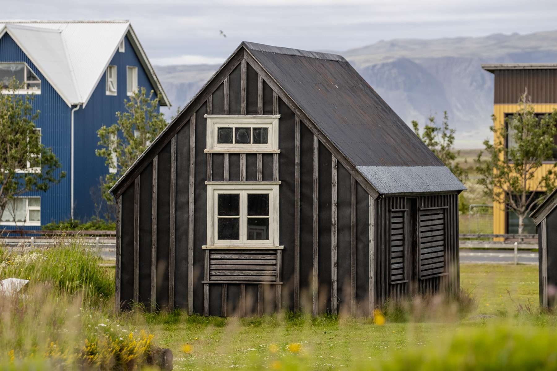 A historic dark wooden cabin in Eyrarbakki, Iceland, July 2025.