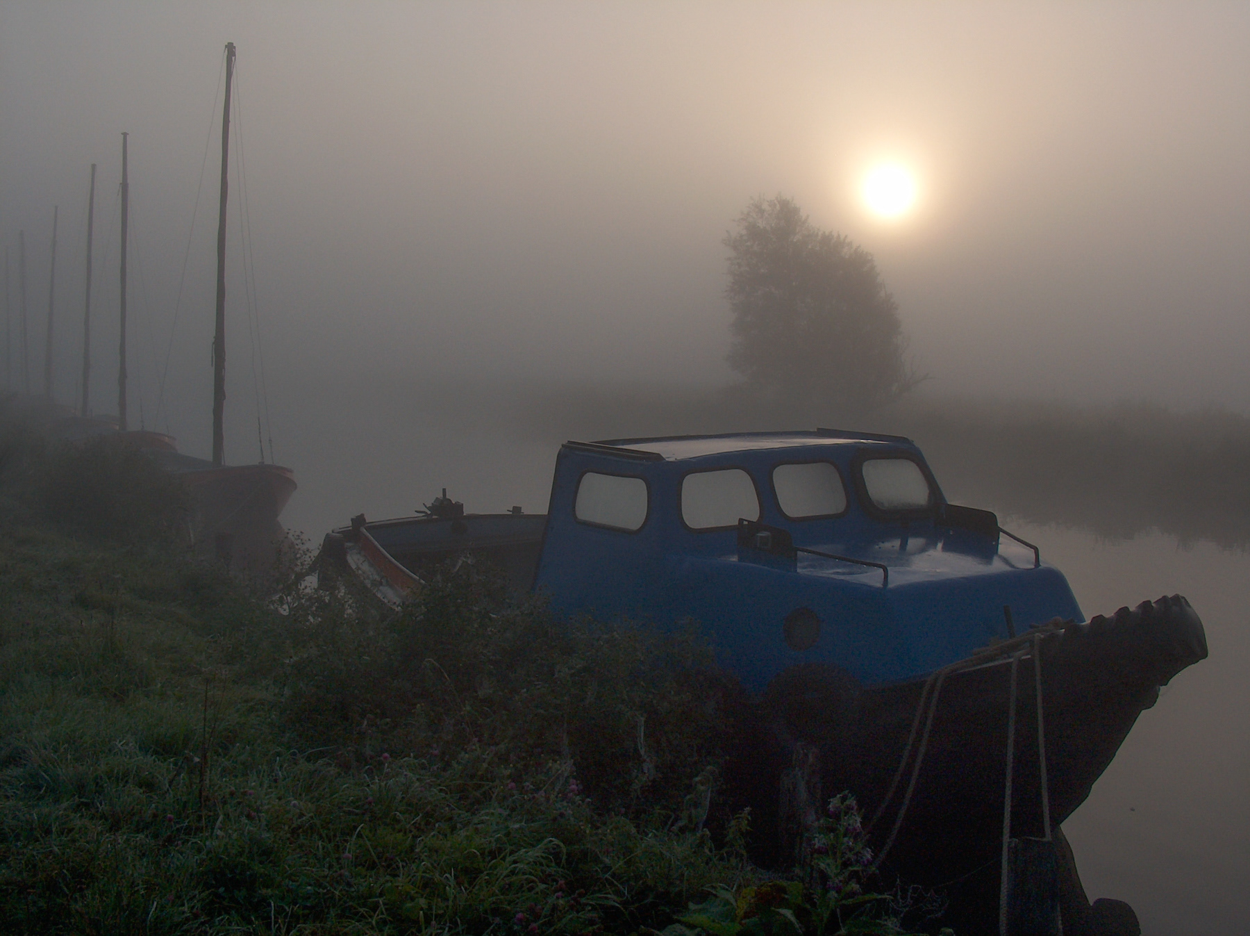 A small historic blue boat in a canal just outside Schipluiden, October 2003.