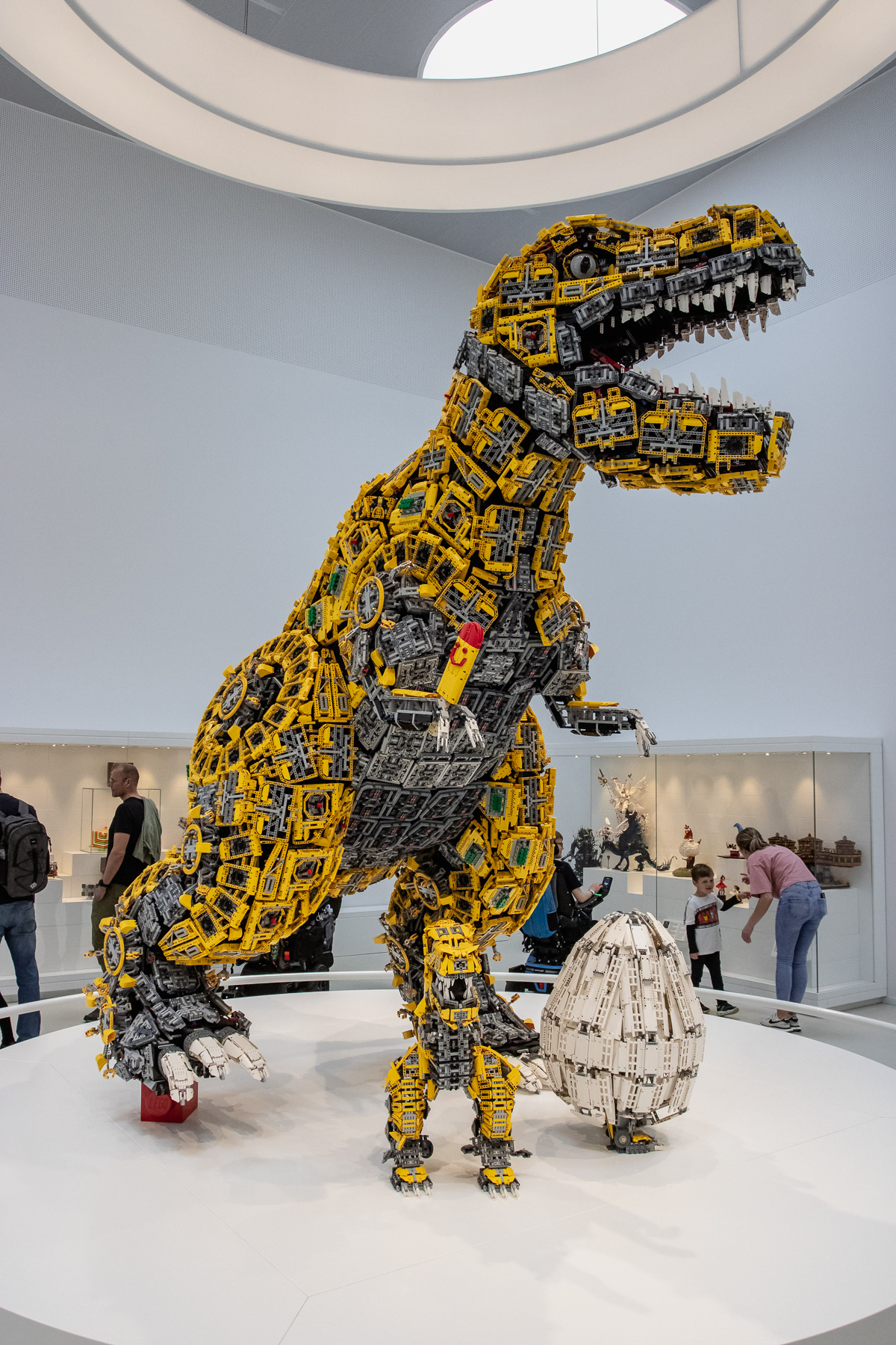 A giant dinosaur screams after stepping on a Lego brick