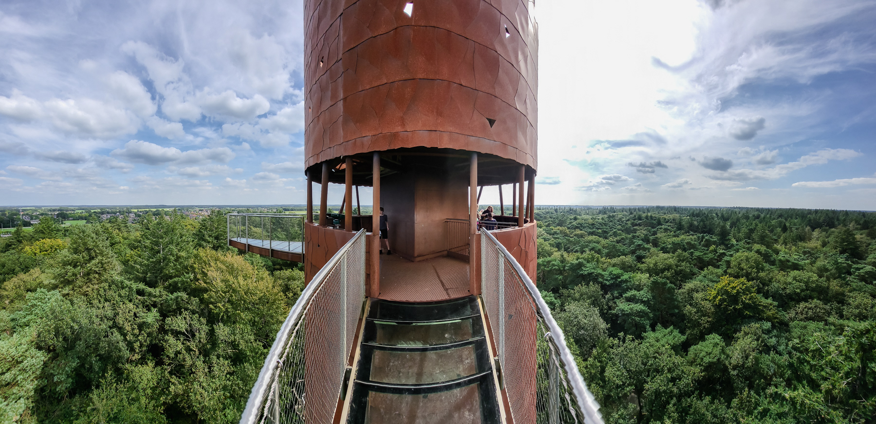 Wide-angle view at the Bosbergtoren viewing tower from the outside edge of one of the glass floor balconies.